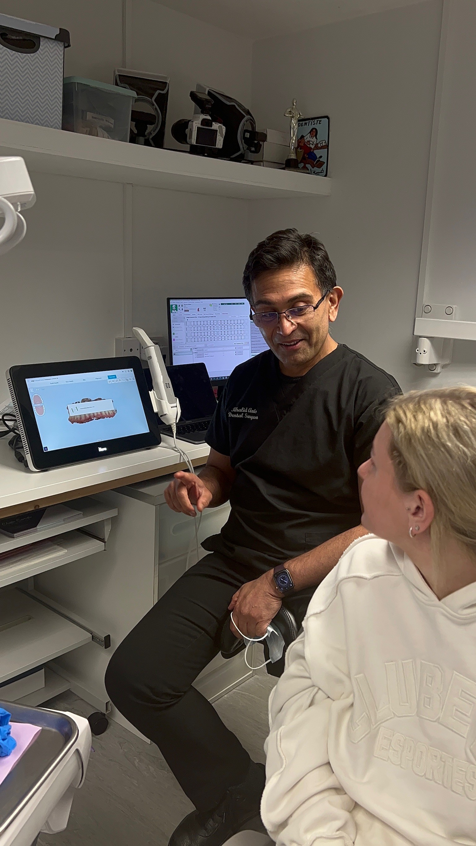 Dr April speaking to a patient about their teeth.