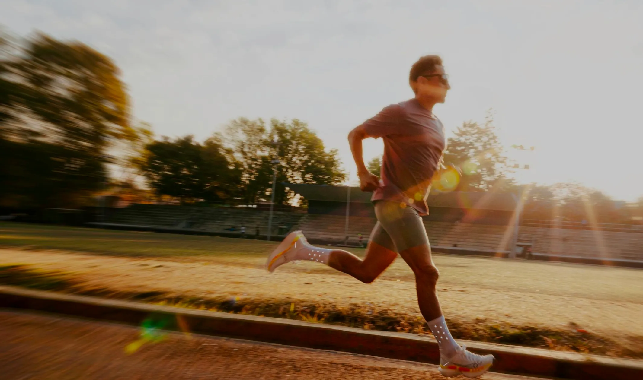 Neura Health Woman sitting in bed wearing glasses and looking at her phone.