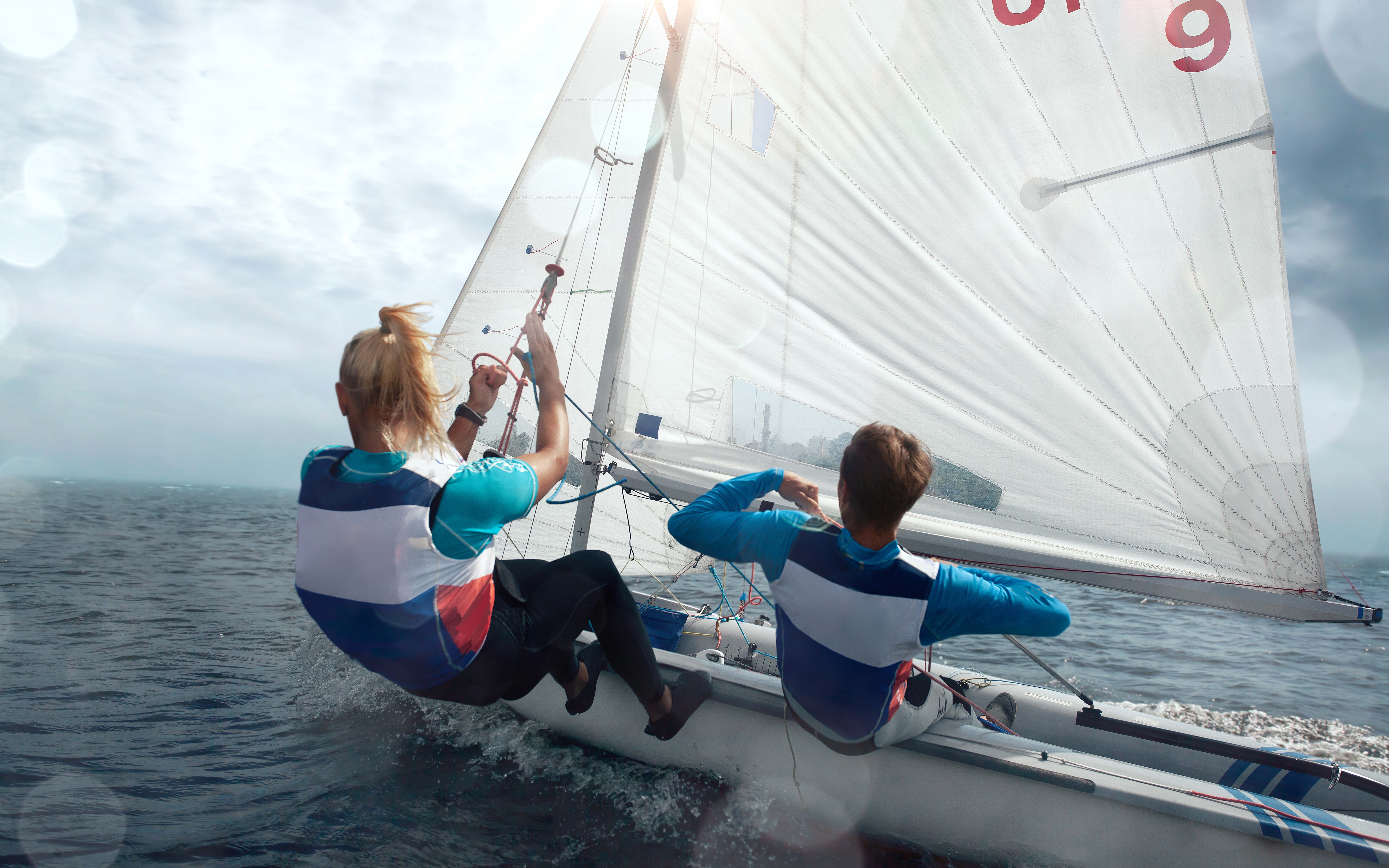 2 person surfing on sea during daytime