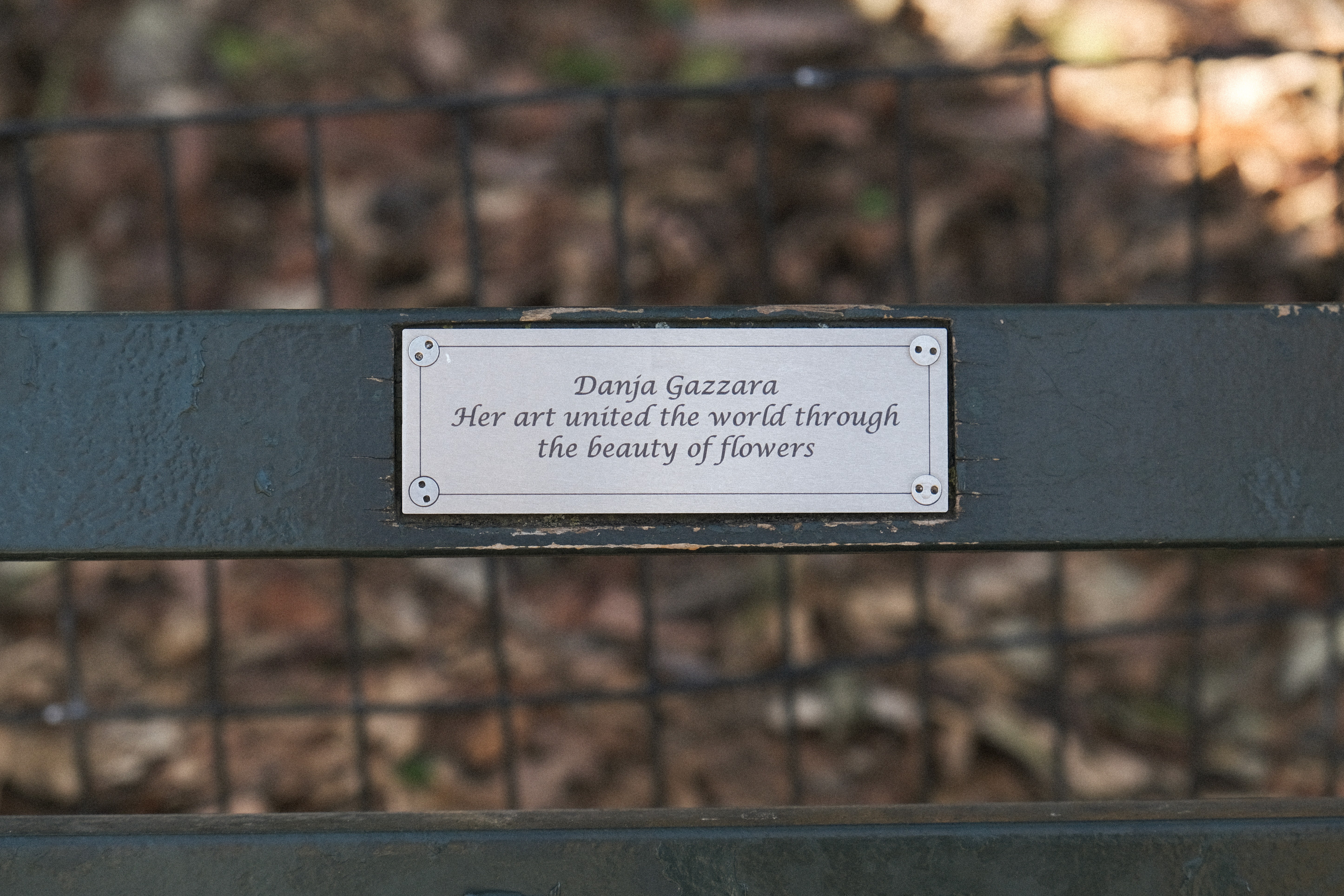 Plaque that reads, "Danja Gazzara / Her art united the world through / the beauty of flowers"