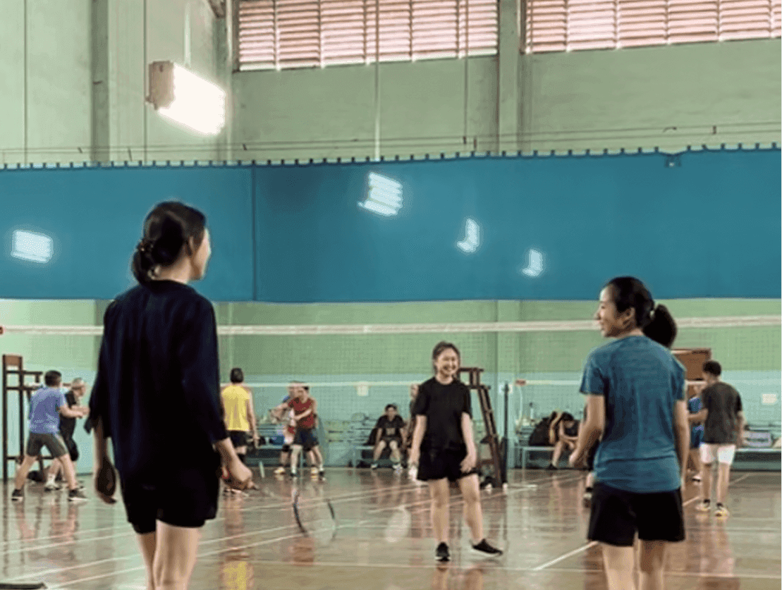Jodith Valerie playing badminton with a friend, work life balance of UI UX designer