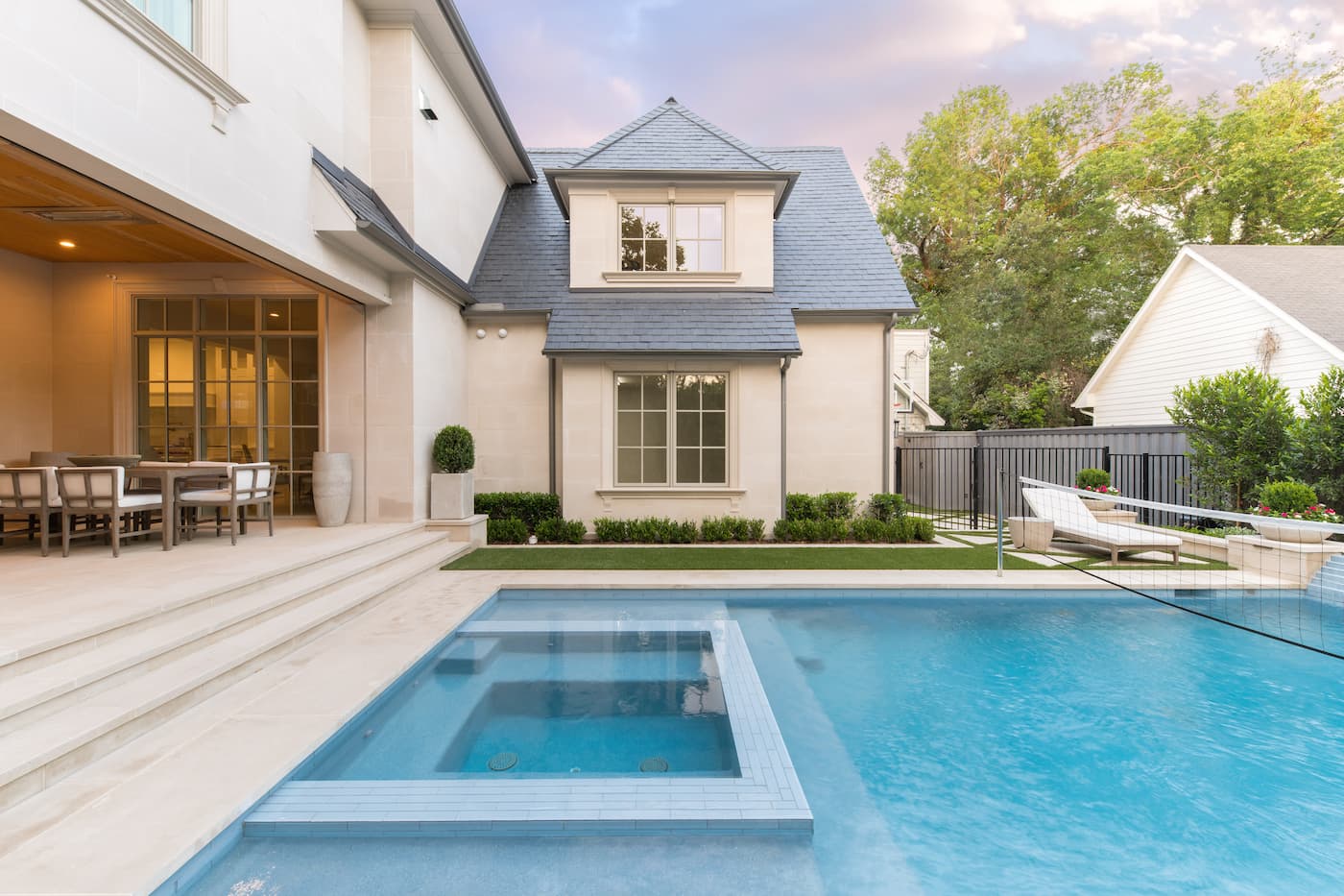 Custom pool with geometric spa integration and clean limestone coping at Park Cities luxury home in Dallas