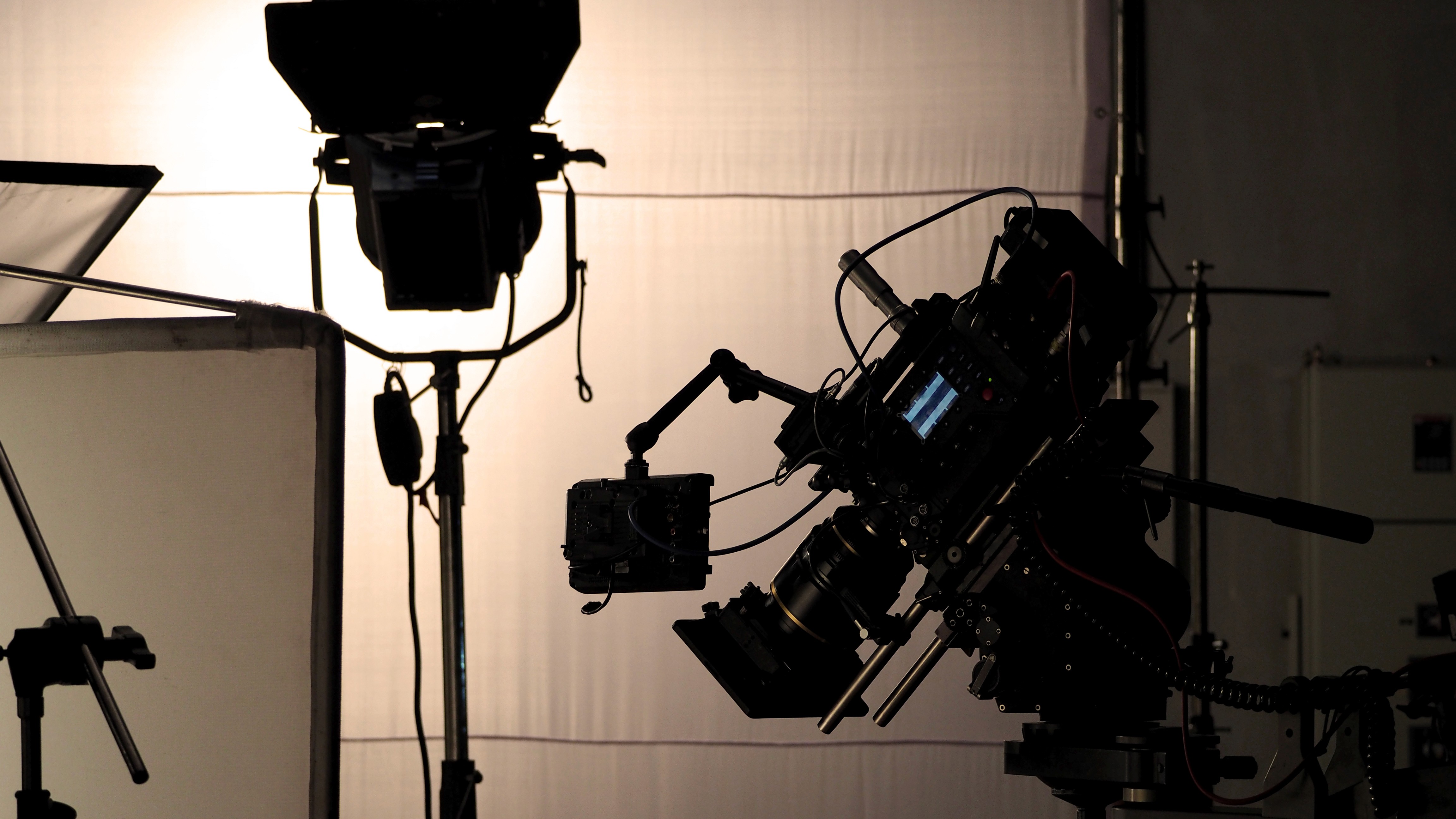 Professional video camera mounted on a tripod on a film set, symbolizing high-quality film and video production services in Kolkata.