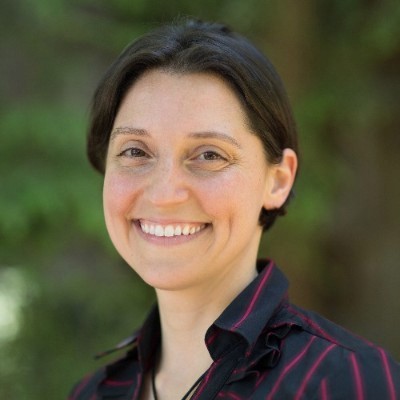Dr. Angela Perone in striped dress shirt, nature background