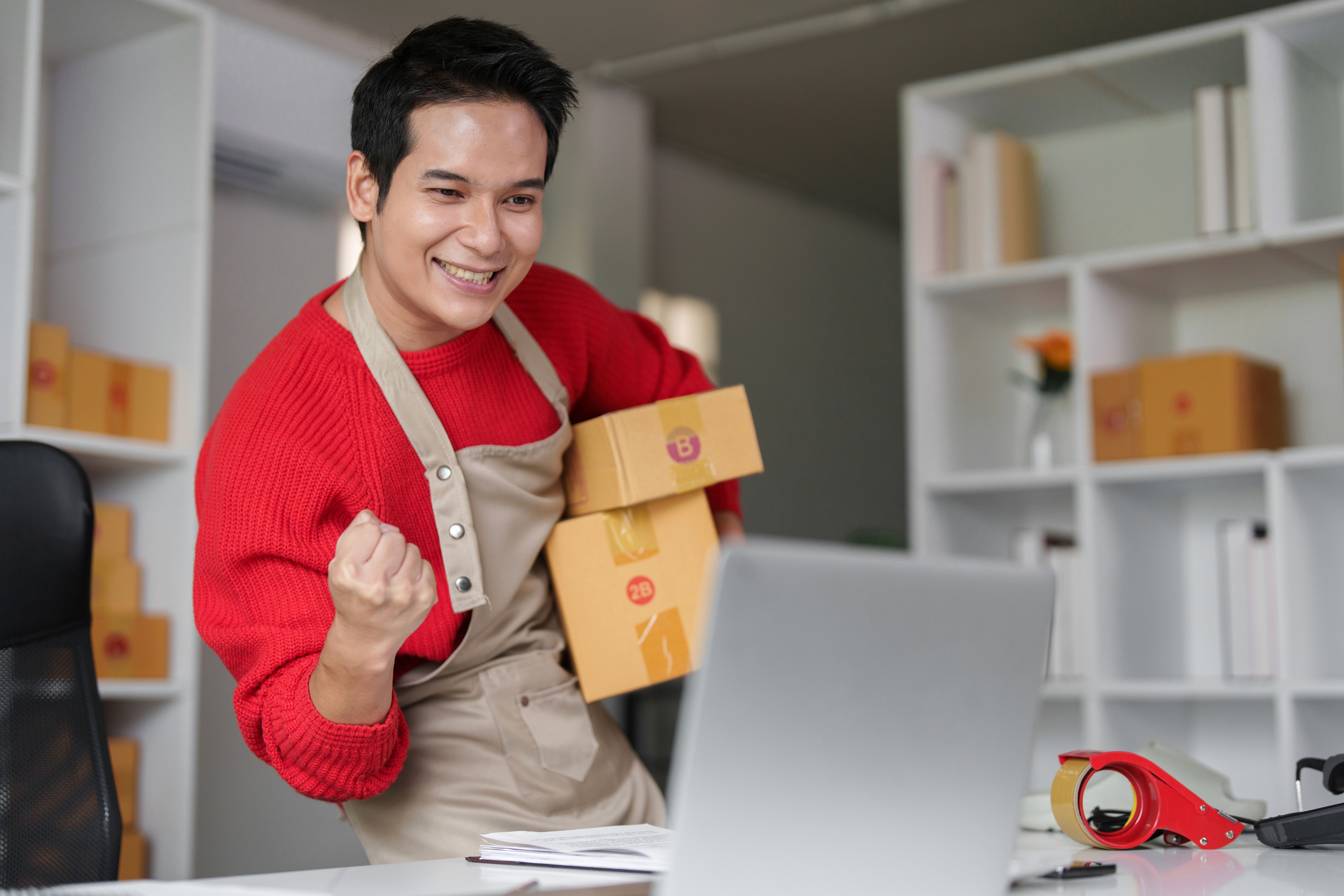 Image of an Entrepreneur celebrating website launch on a laptop