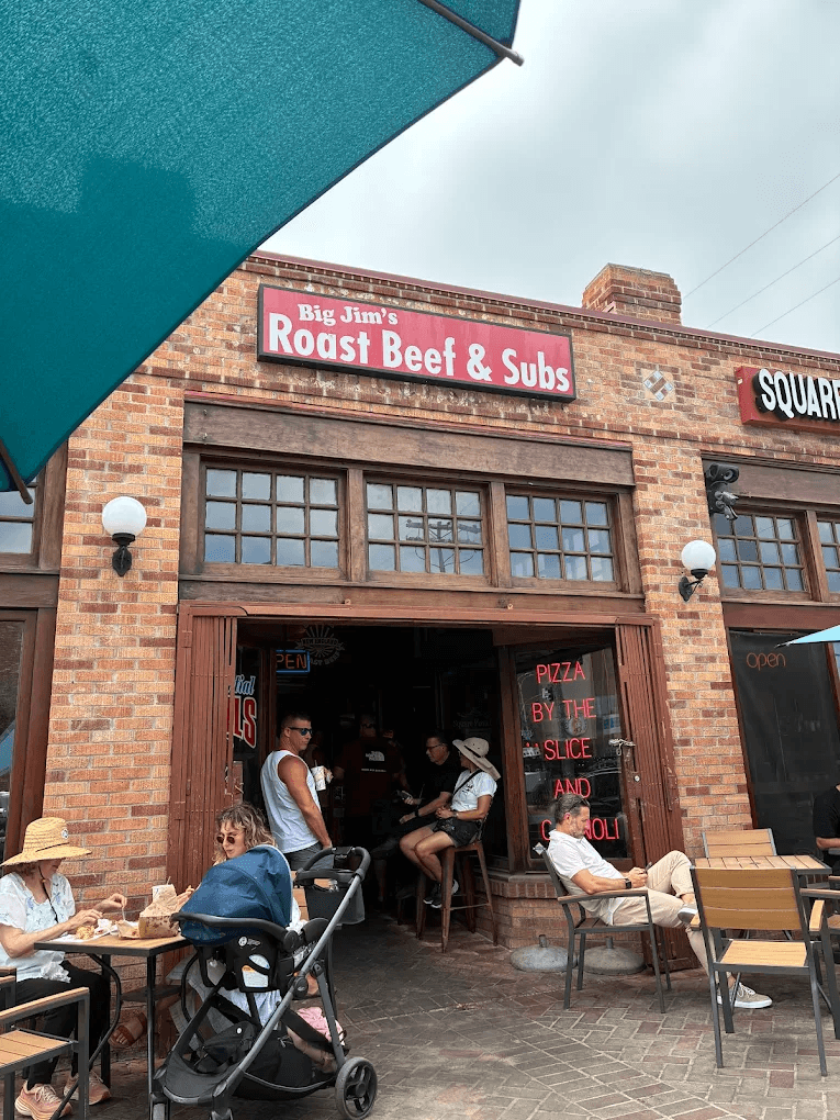 The outside exterior of Big Jim's Roast Beef with a crowd of locals enjoying the best sandwiches and subs in Pacific Beach, San Diego
