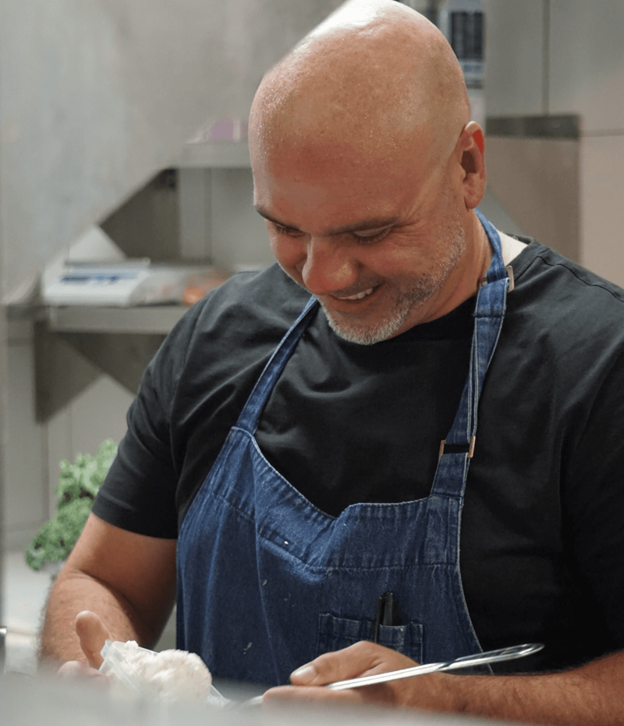 Portrait of the head chef standing at the restaurant entrance.