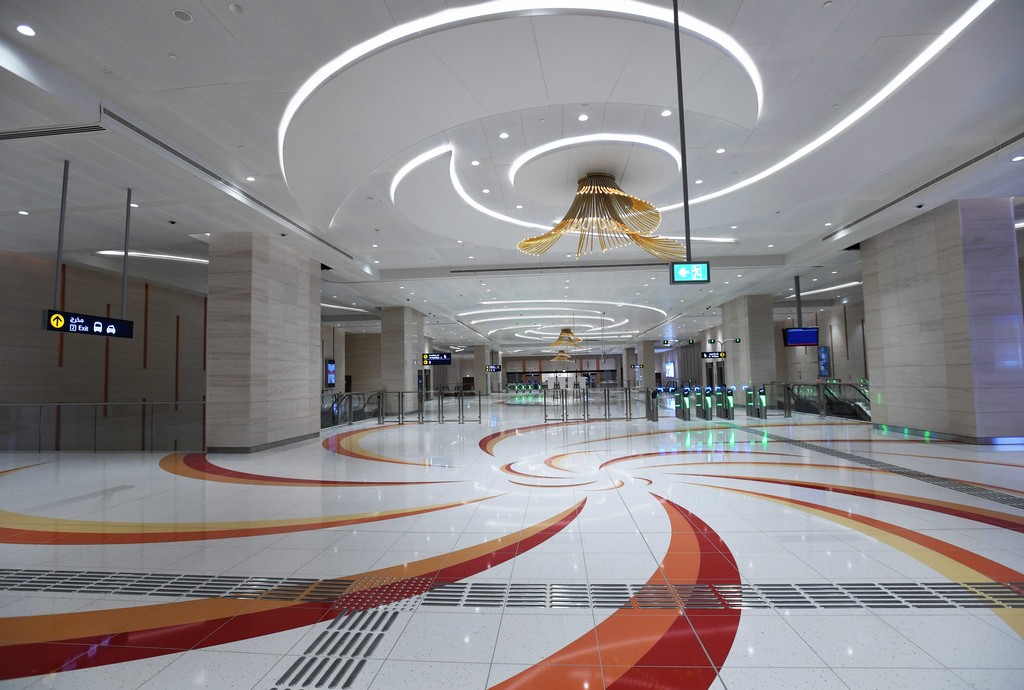 Jumeirah Golf Estates metro station entrance near Santorini, featuring modern architecture and surrounding greenery.