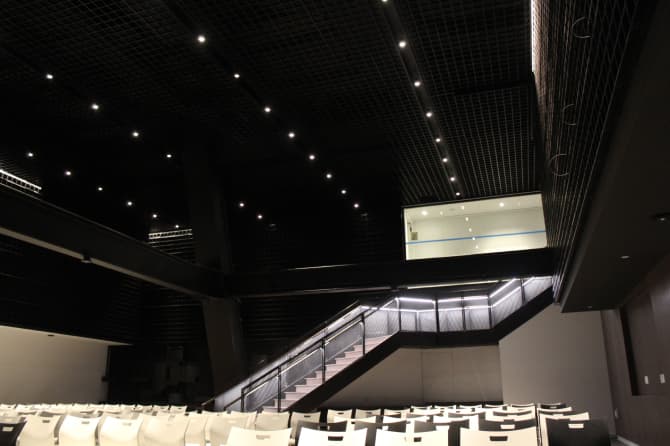 A dark ceiling with small bright lights built in