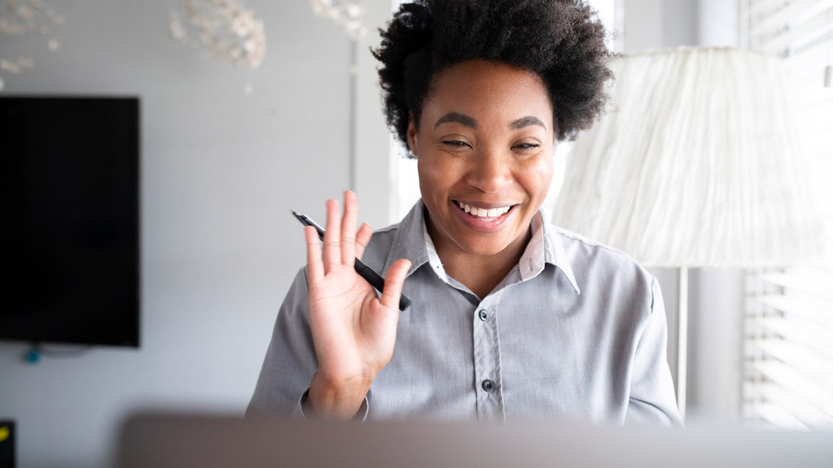 A design thinking facilitator smiling and welcoming participants during a workshop