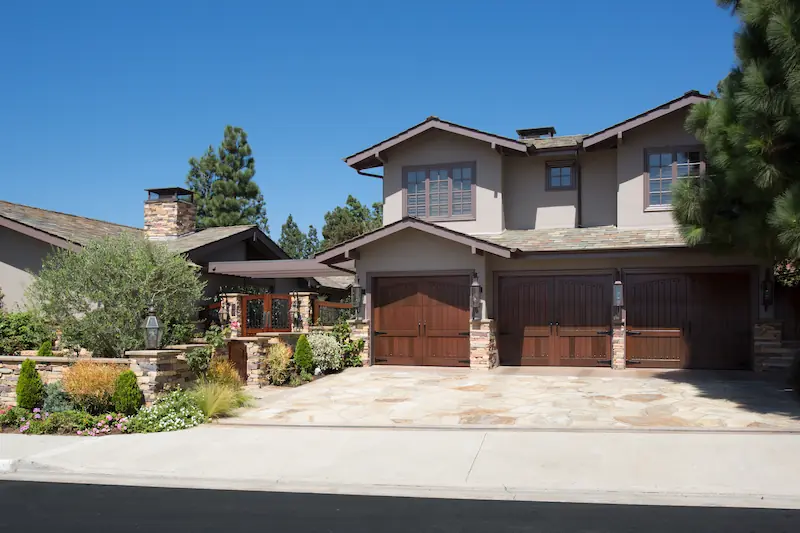 Street view of the Big Canyon Remodel project. Beautiful 2 story home with 3 car garage with gorgeous walnut garage doors.Photo by Chris Darnall.