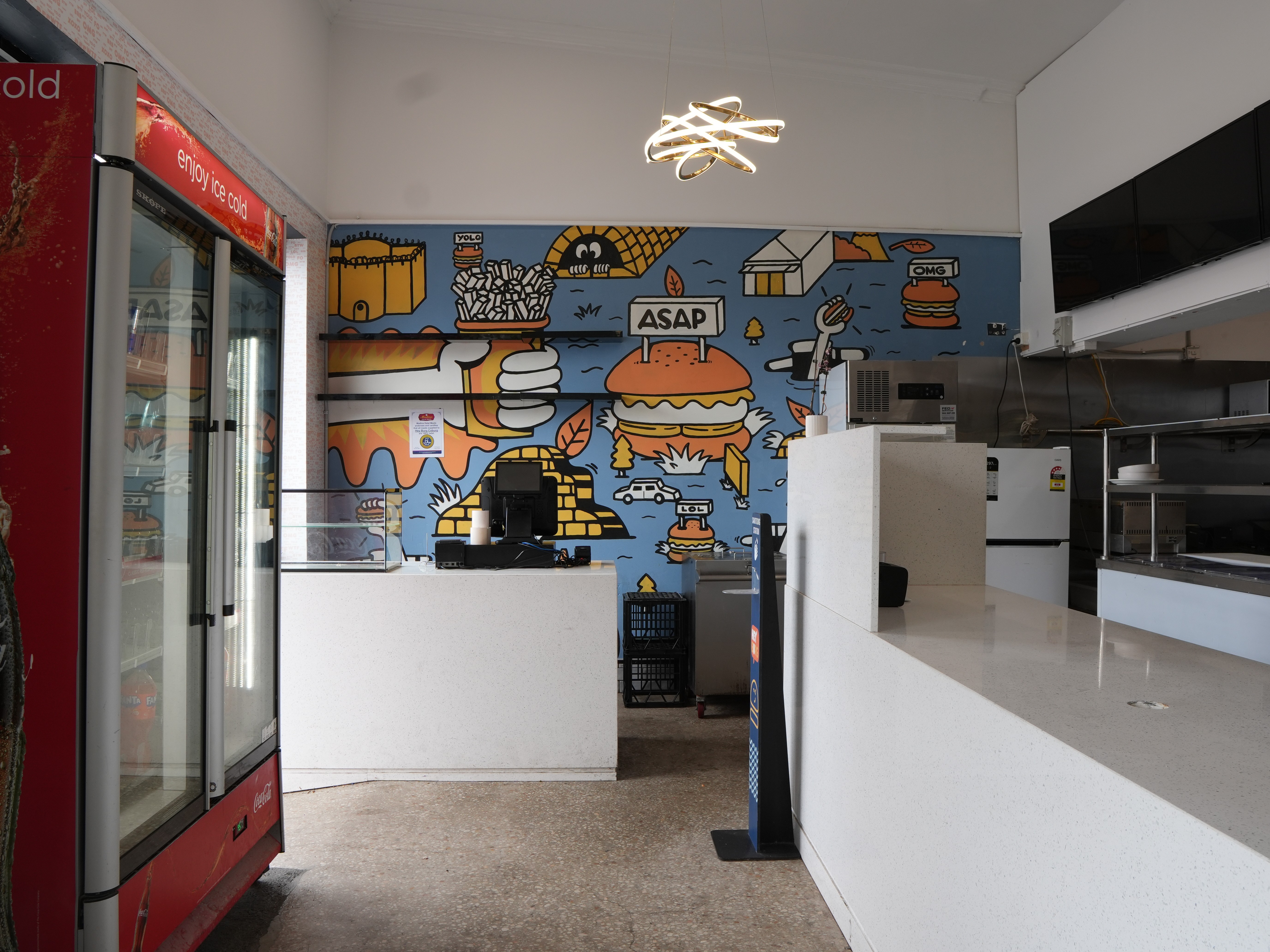 Hospitality fit-out for Heyburg in Coburg, Victoria with neon Hey'Burg signage, terrazzo counter, custom pop-art murals, brass pedestal tables, pendant lighting.
