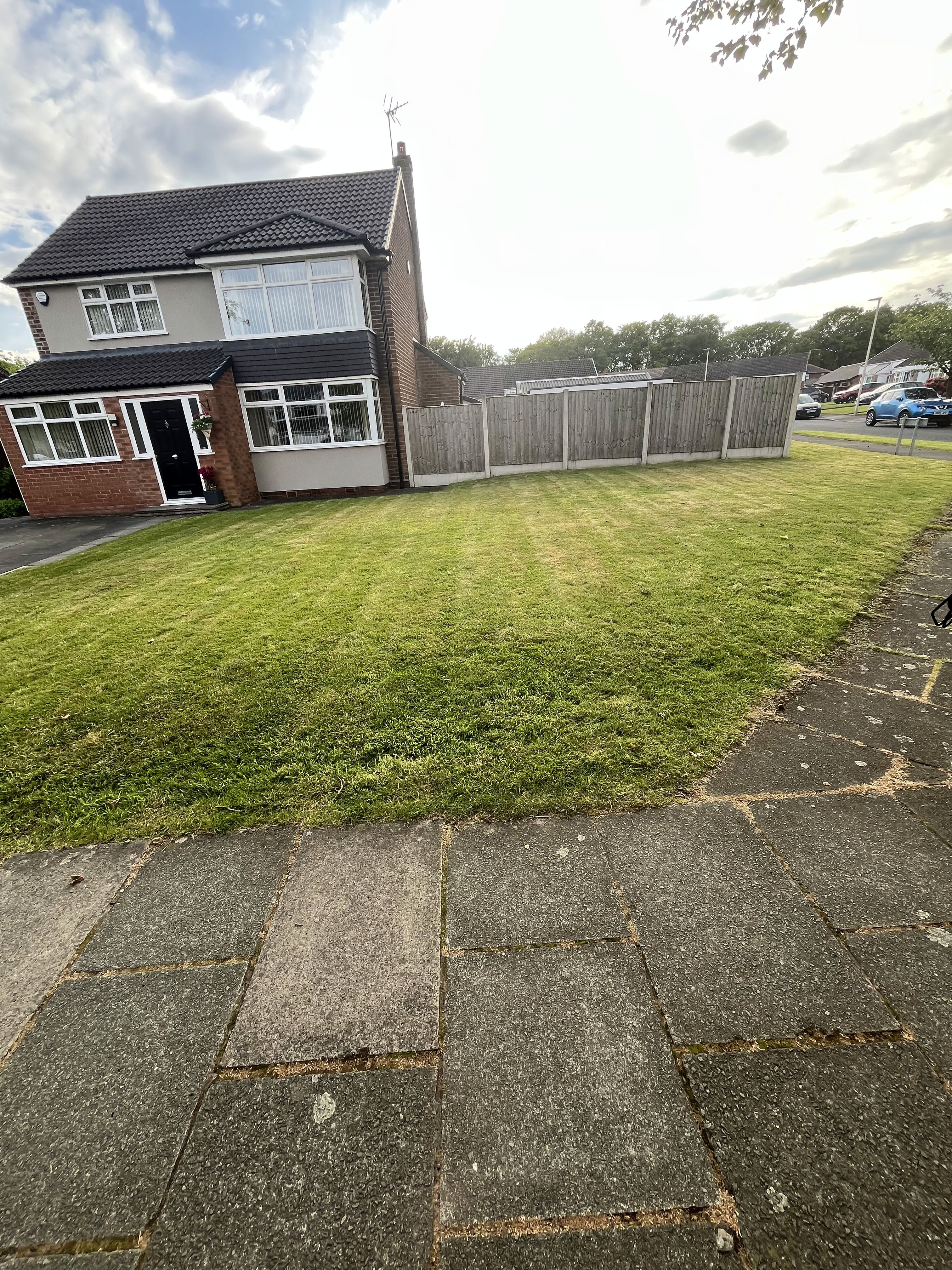 brown and white concrete house near green grass field during daytime