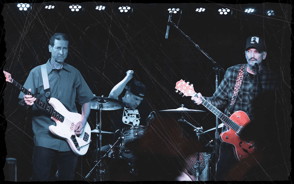 Dead Kampers band members, Gary Boondt on bass, Holland Barry on drums, and Donny Campion on guitar playing at Moe's Alley in Santa Cruz, CA.