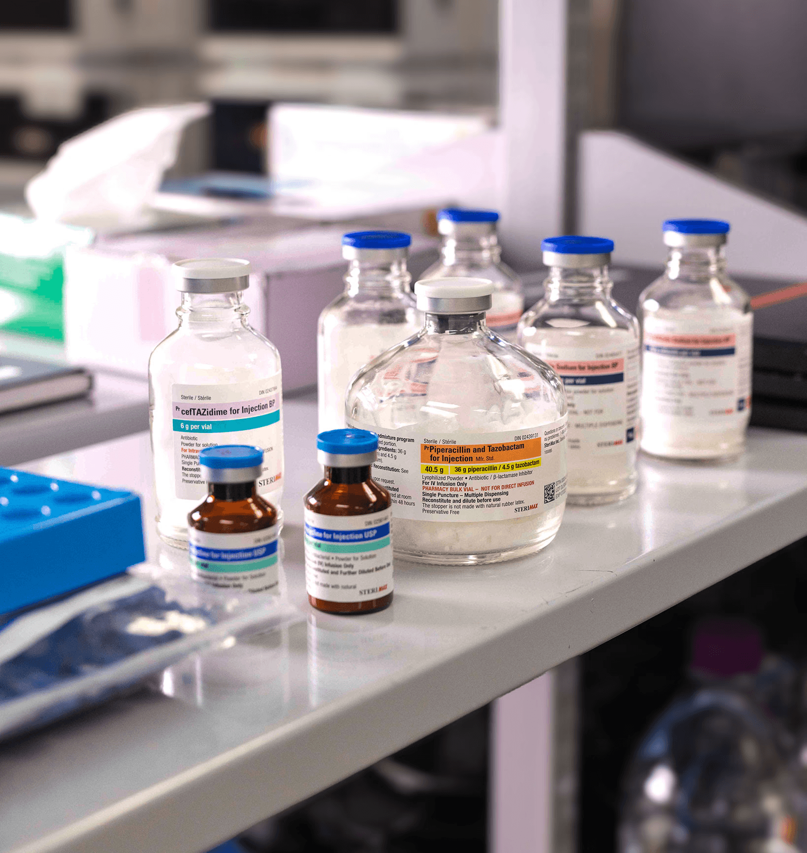 Close-up of a scientist wearing gloves carefully handling a labeled flask in a laboratory.