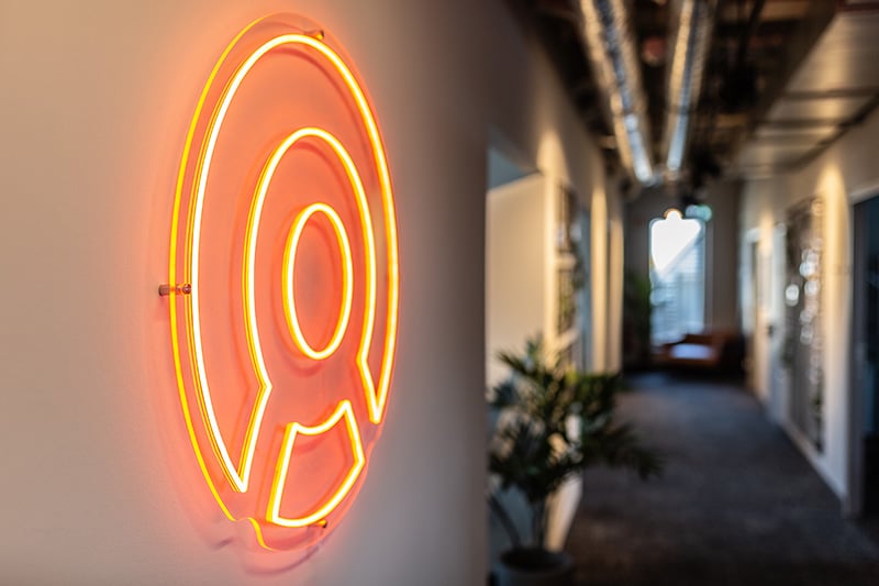 Illuminated Sovendus logo on an office wall