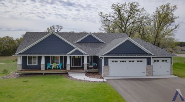 New house blue siding three stall garage with porch