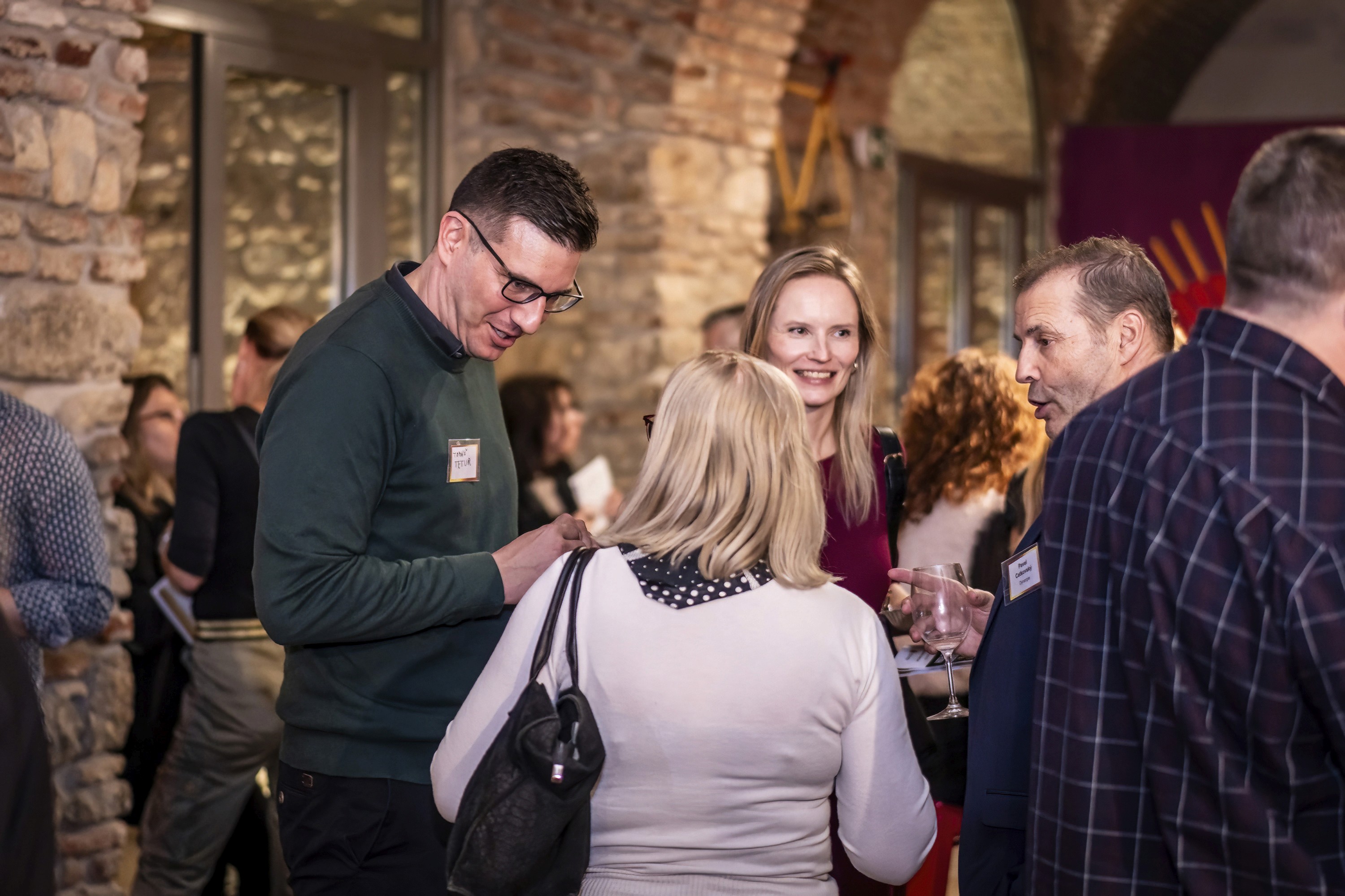 Conference attendees networking and talking during a social break.