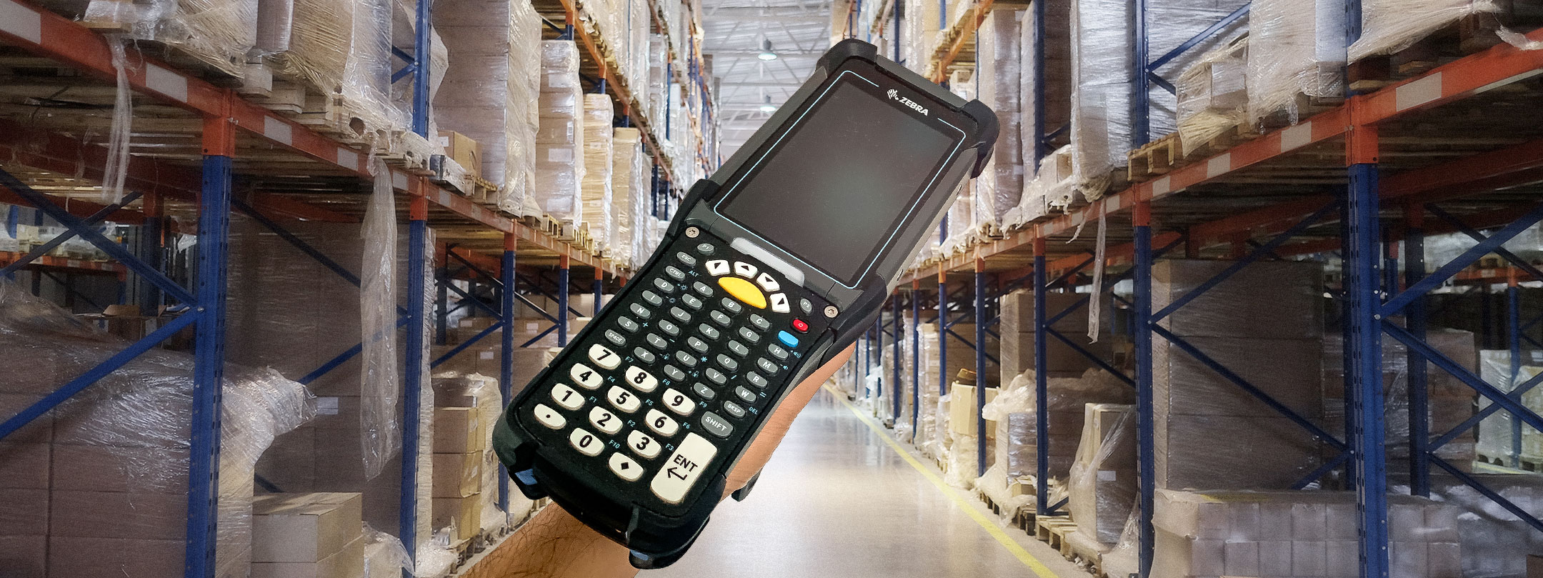 A person scans a barcode with a handheld device, focusing on a blue object nearby.
