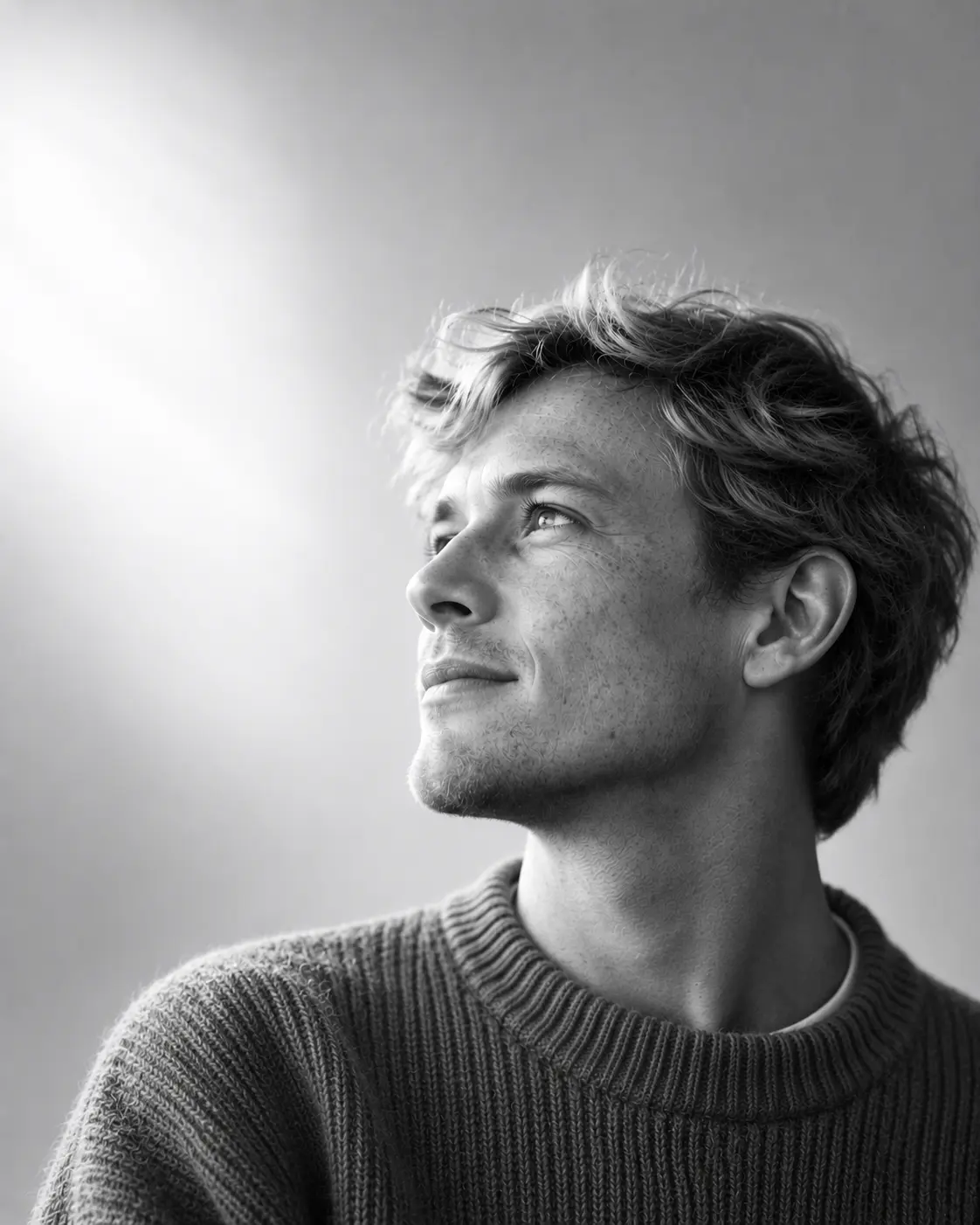 Rhys Penhale, senior tax advisor, with tousled light hair and a grey ribbed knit, looking up and to the left