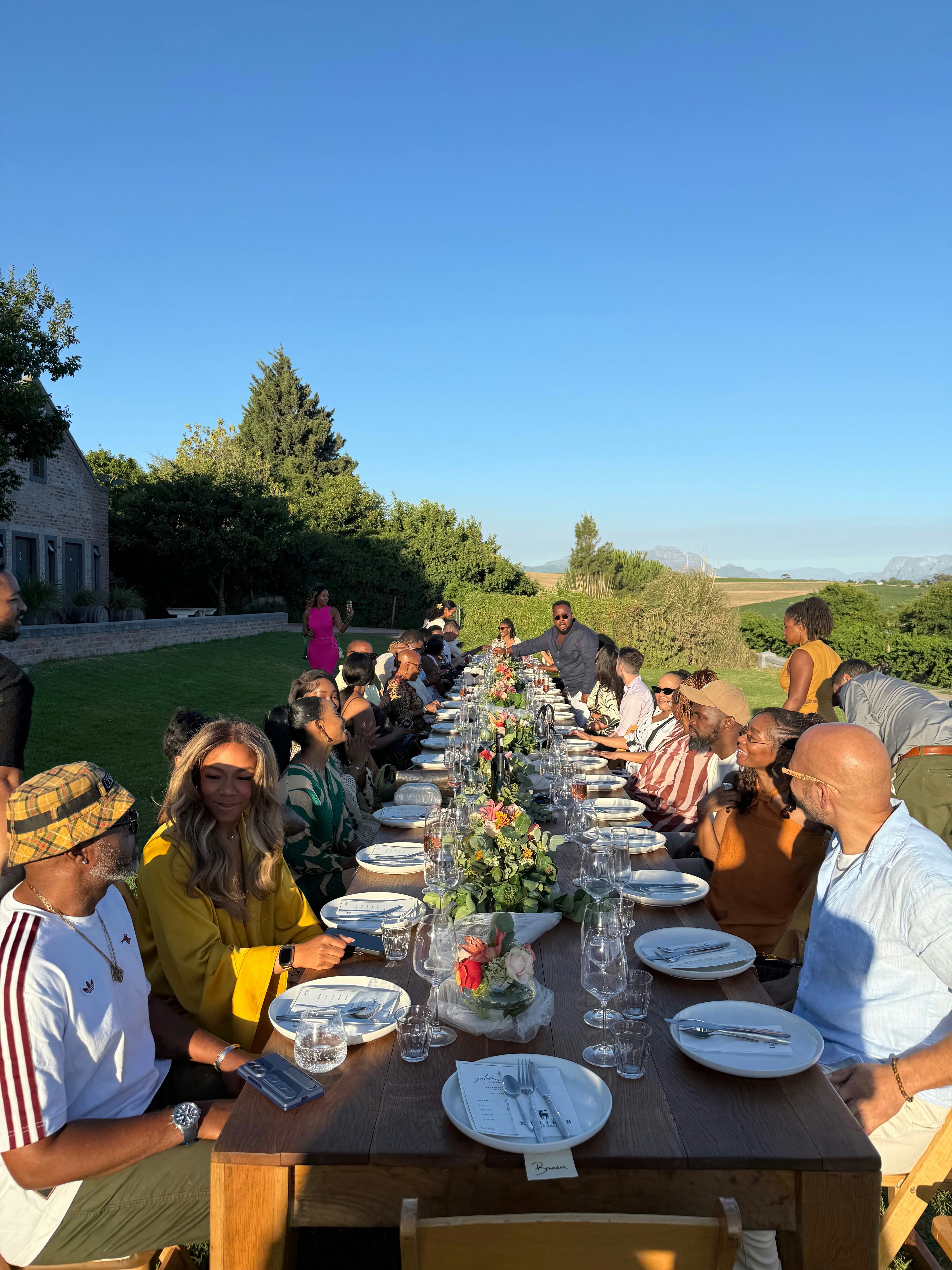 Friends gathered around a long outdoor table