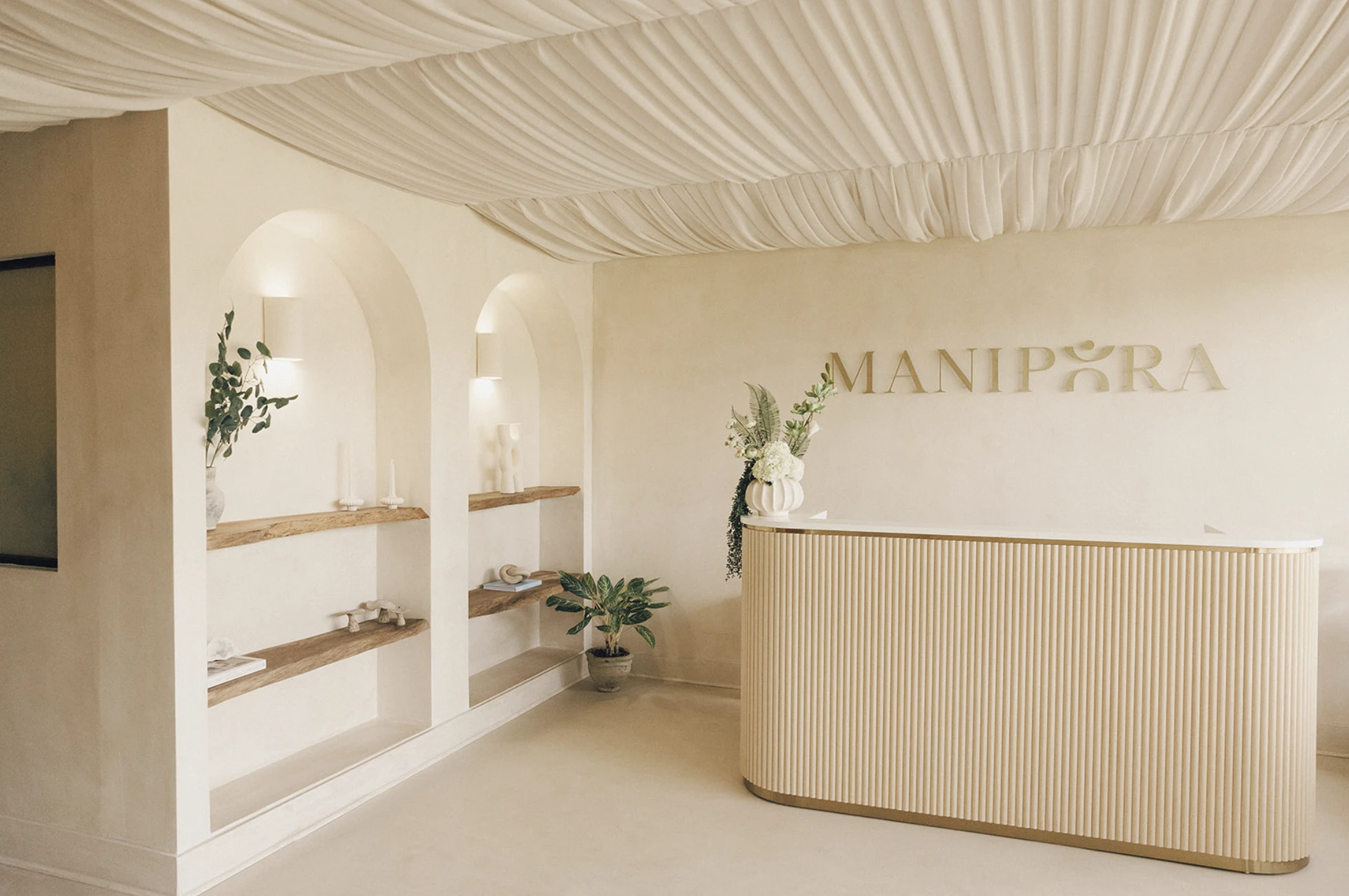 Manipura wellness clinic reception interior with custom dimensional wall logo signage