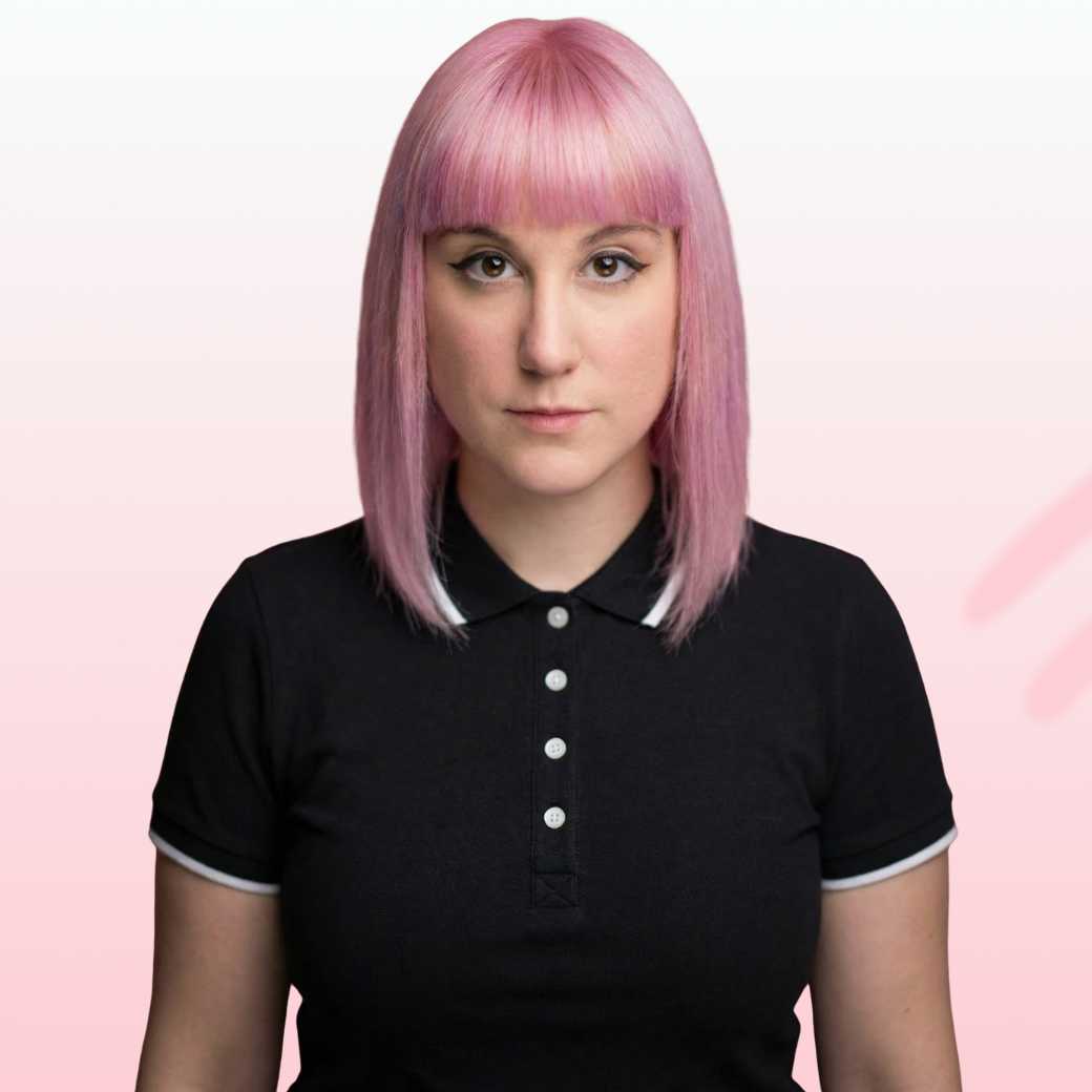 Smiling man with light brown hair and stubble, wearing a khaki shirt in natural light