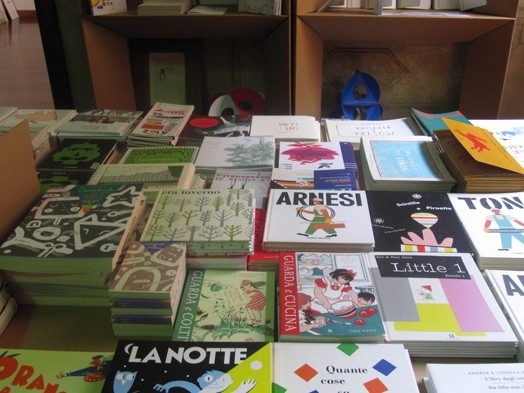 A photo of a desk filled with books.