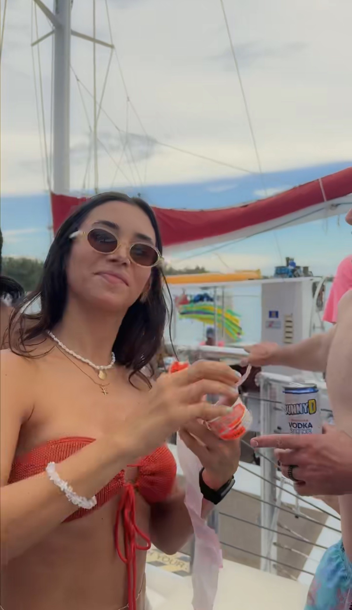 sitting woman carrying backpack overlooking canyon during daytime