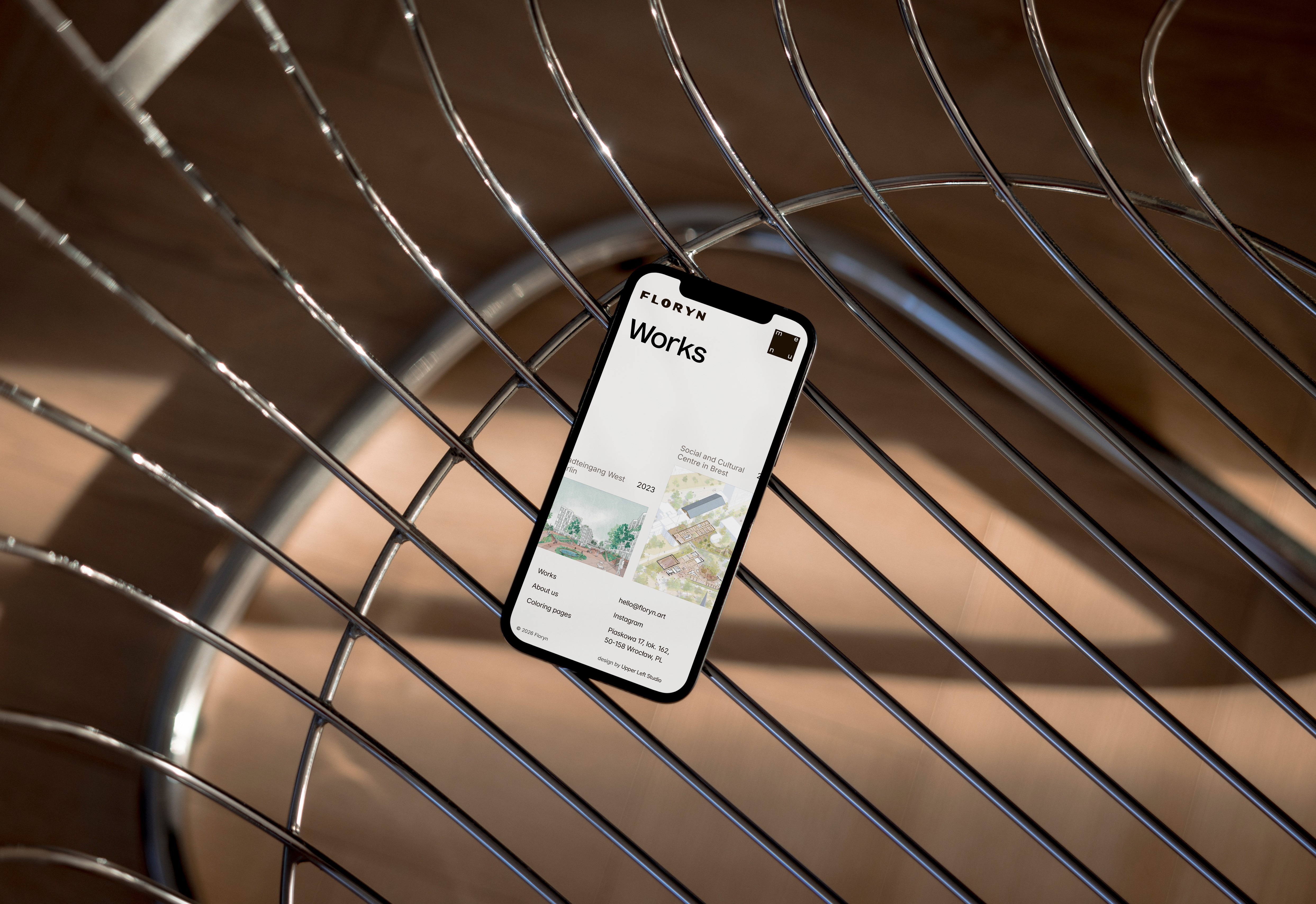 A smartphone lies on a surface, displaying a faint purple screen, with a dark case surrounding it.