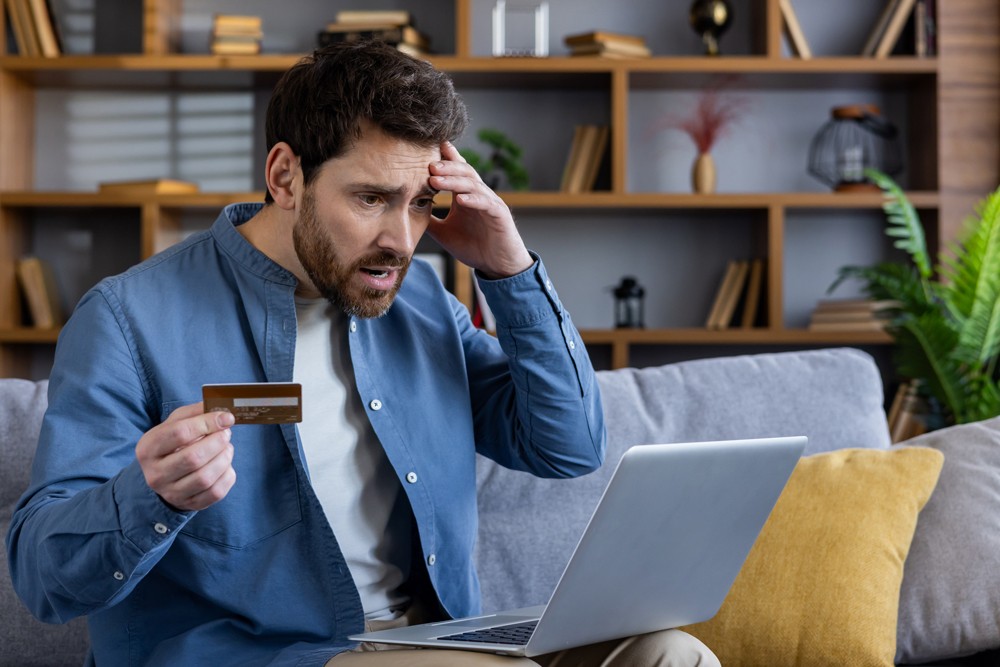 A man in shock seeing his subscription cost at the end of the month