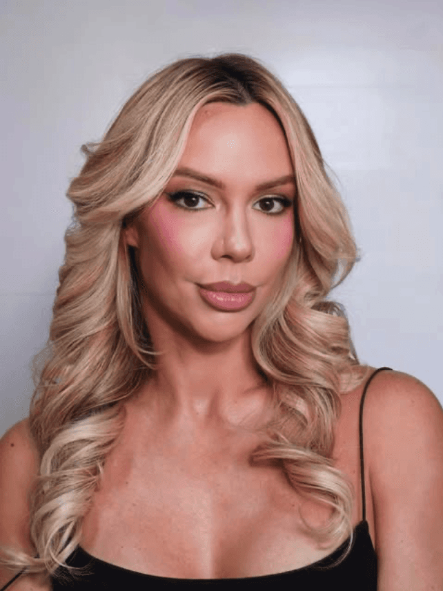 Beautiful woman holding a skin care product