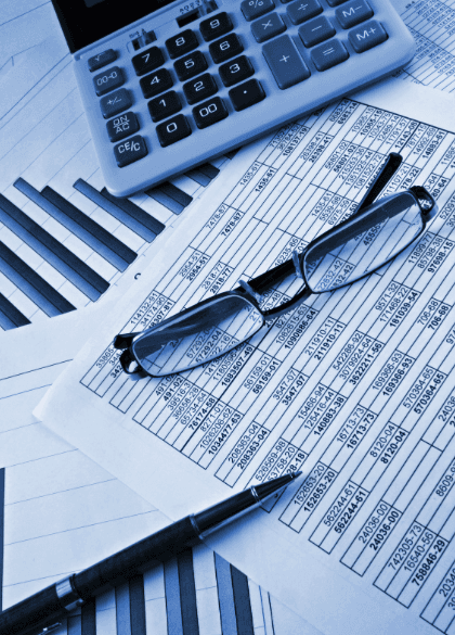 Calculator and financial documents representing professional small business bookkeeping services by BM Bookkeeping