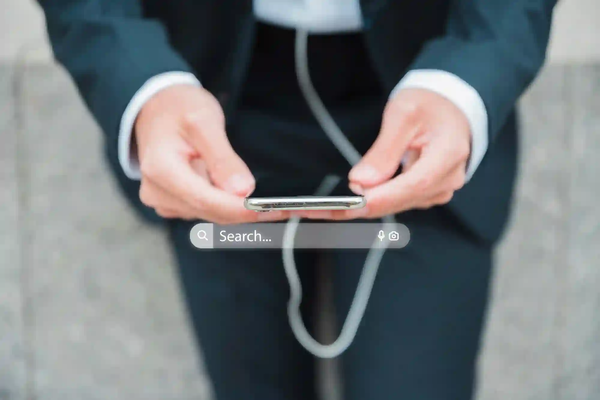 A professional using a smartphone with an overlay search bar, highlighting mobile search optimization and instant information access.