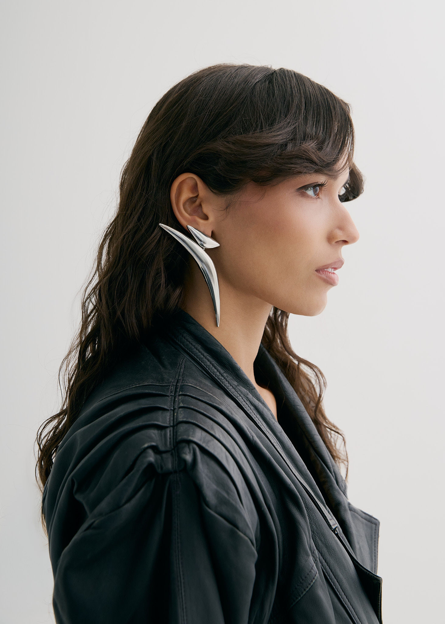 Woman walking on a curved pavement with shadow.