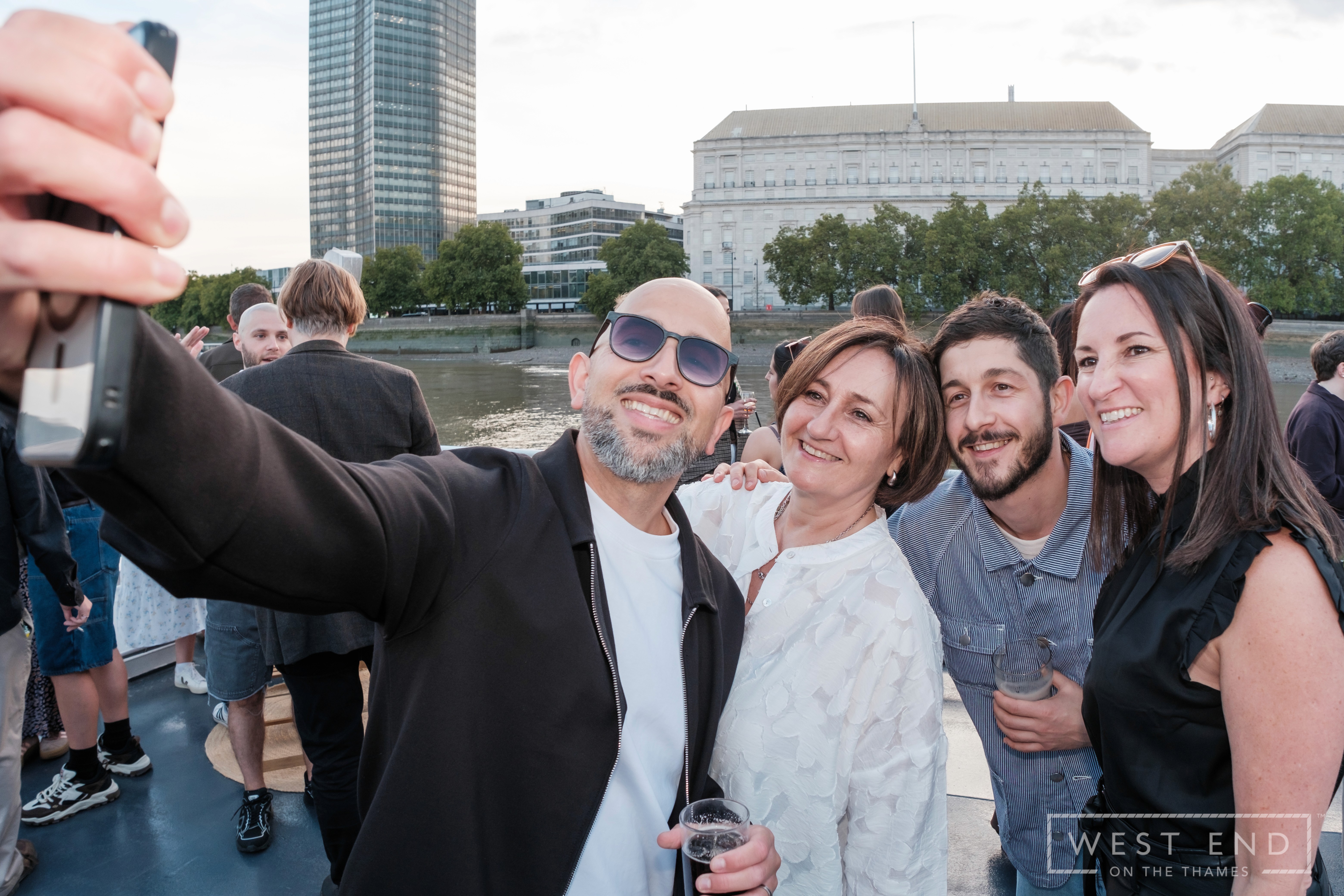 four people having a selfie. 