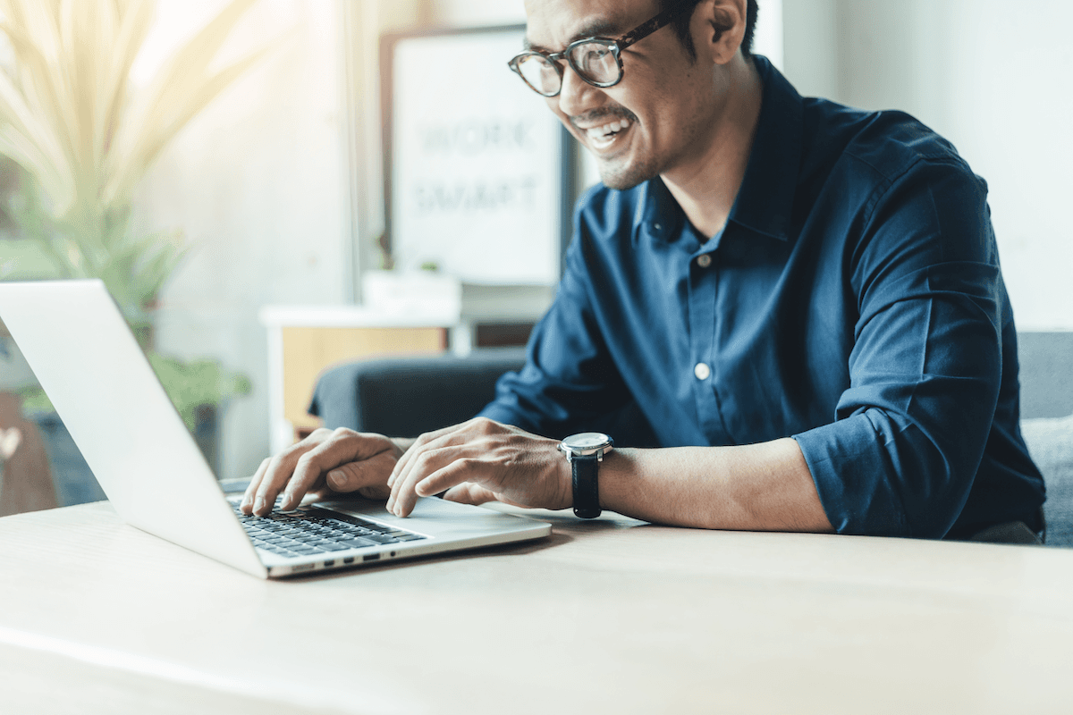 product tour: Smiling man using his laptop