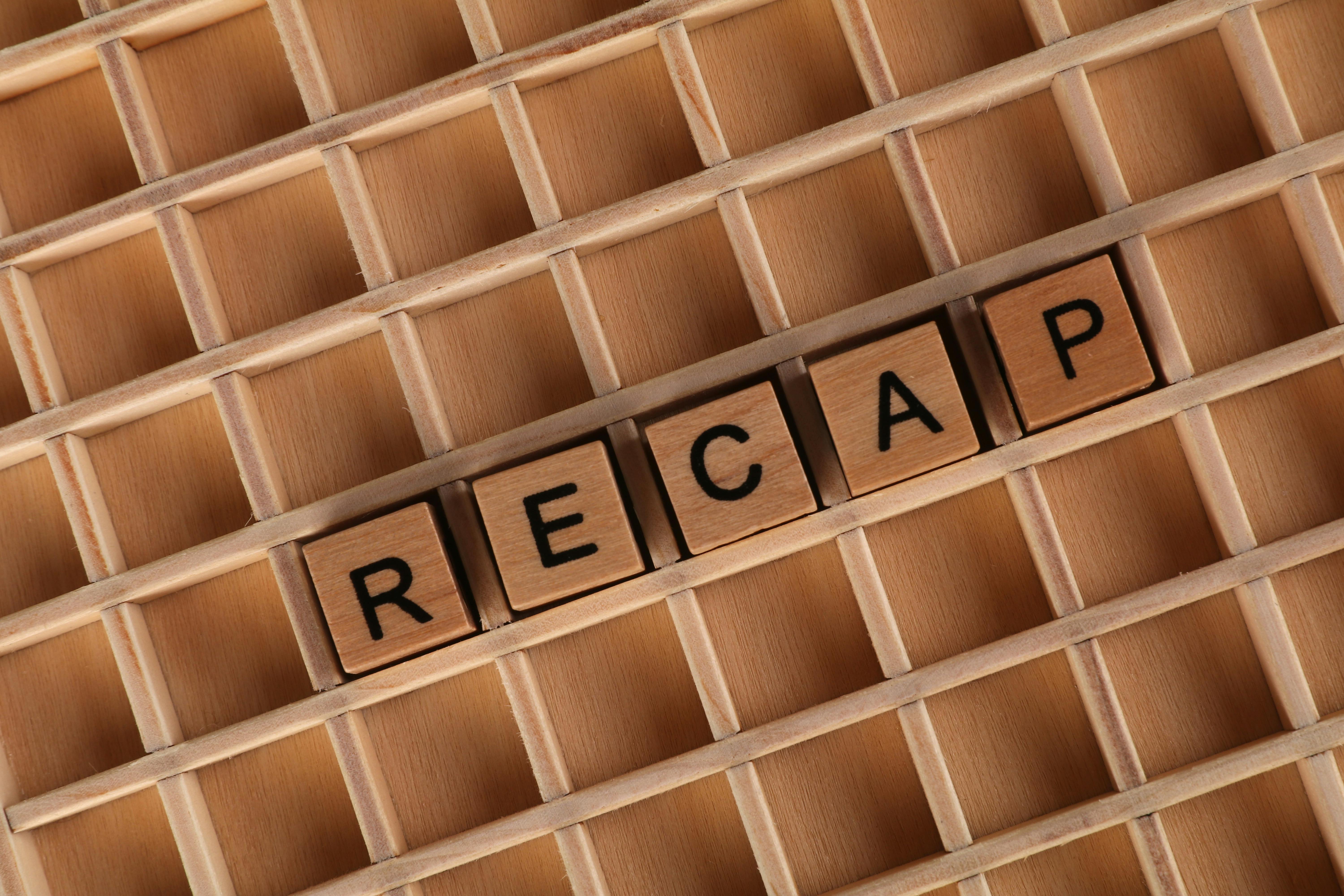 Wooden Letter Blocks Spelling 'Recap' on a Grid