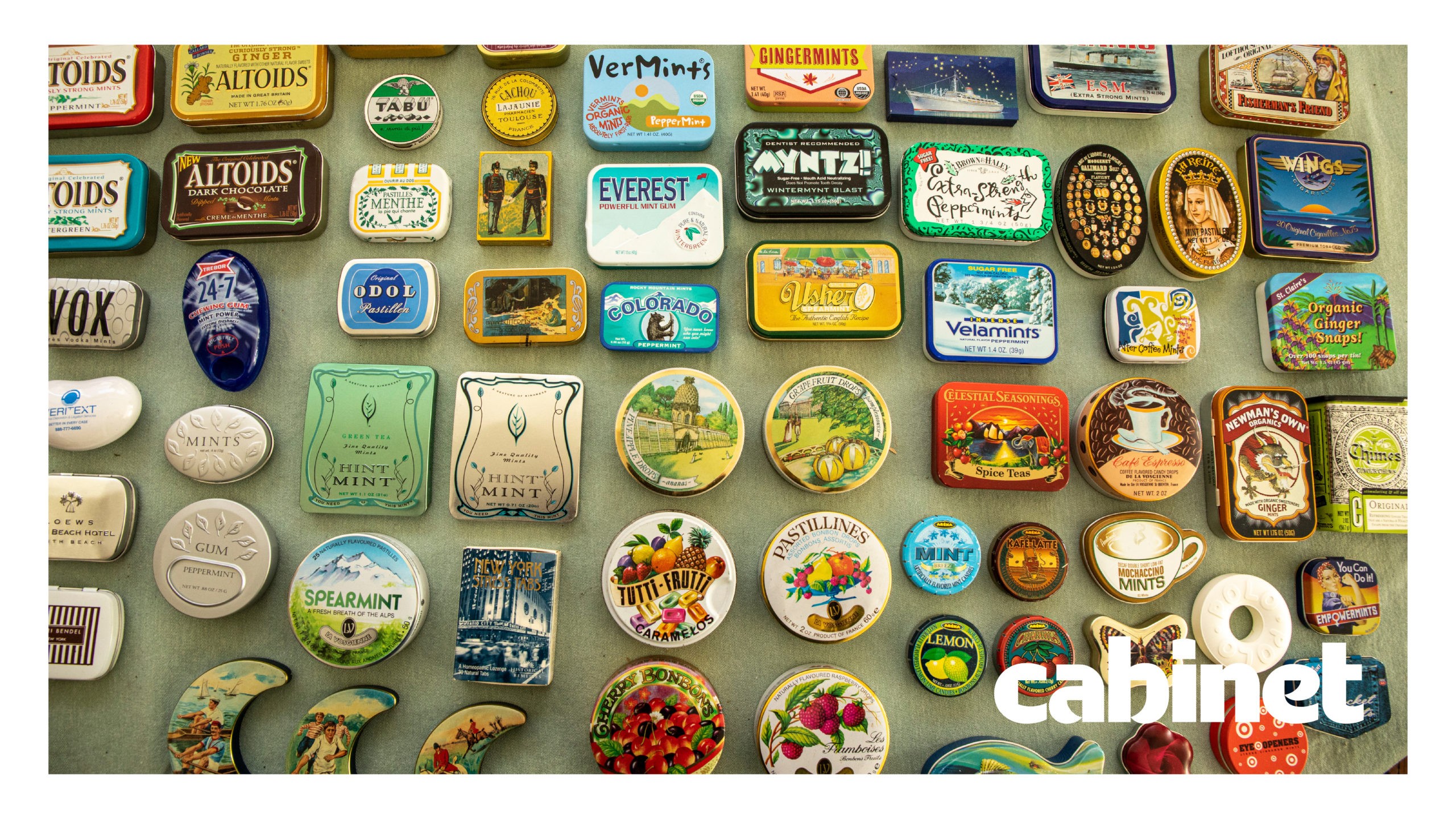 A collection of colorful, vintage-style magnets arranged on a light gray surface. The magnets depict various food-related images and text, including labels like "Todos," "Altoids," "Dark Chocolate," "Everest," "Mint," "Spice," "Mint," and "Cabinet."