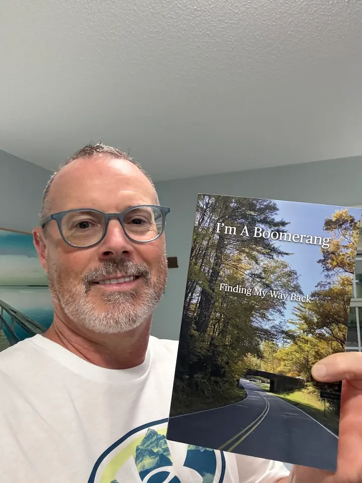 Stuart Simpson holding his book I’m a Boomerang.