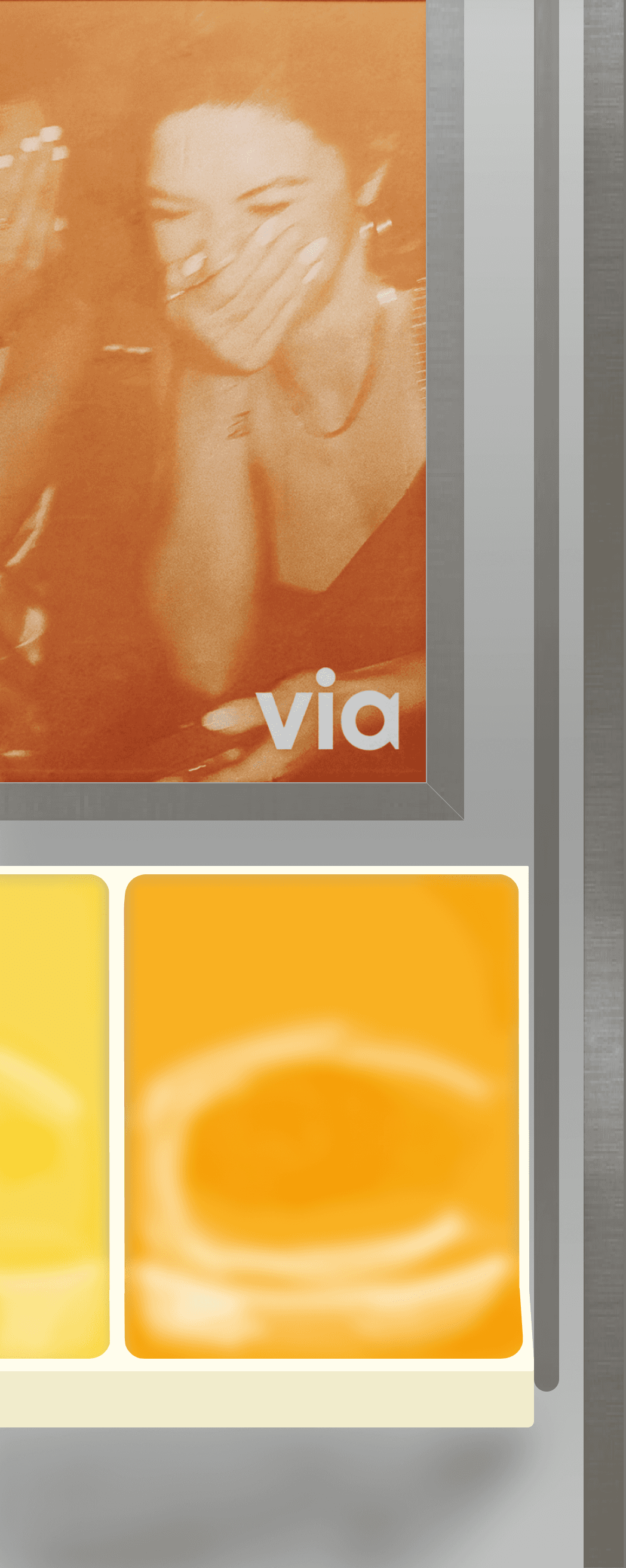 left side of a subway car with an ad for via and orange seats