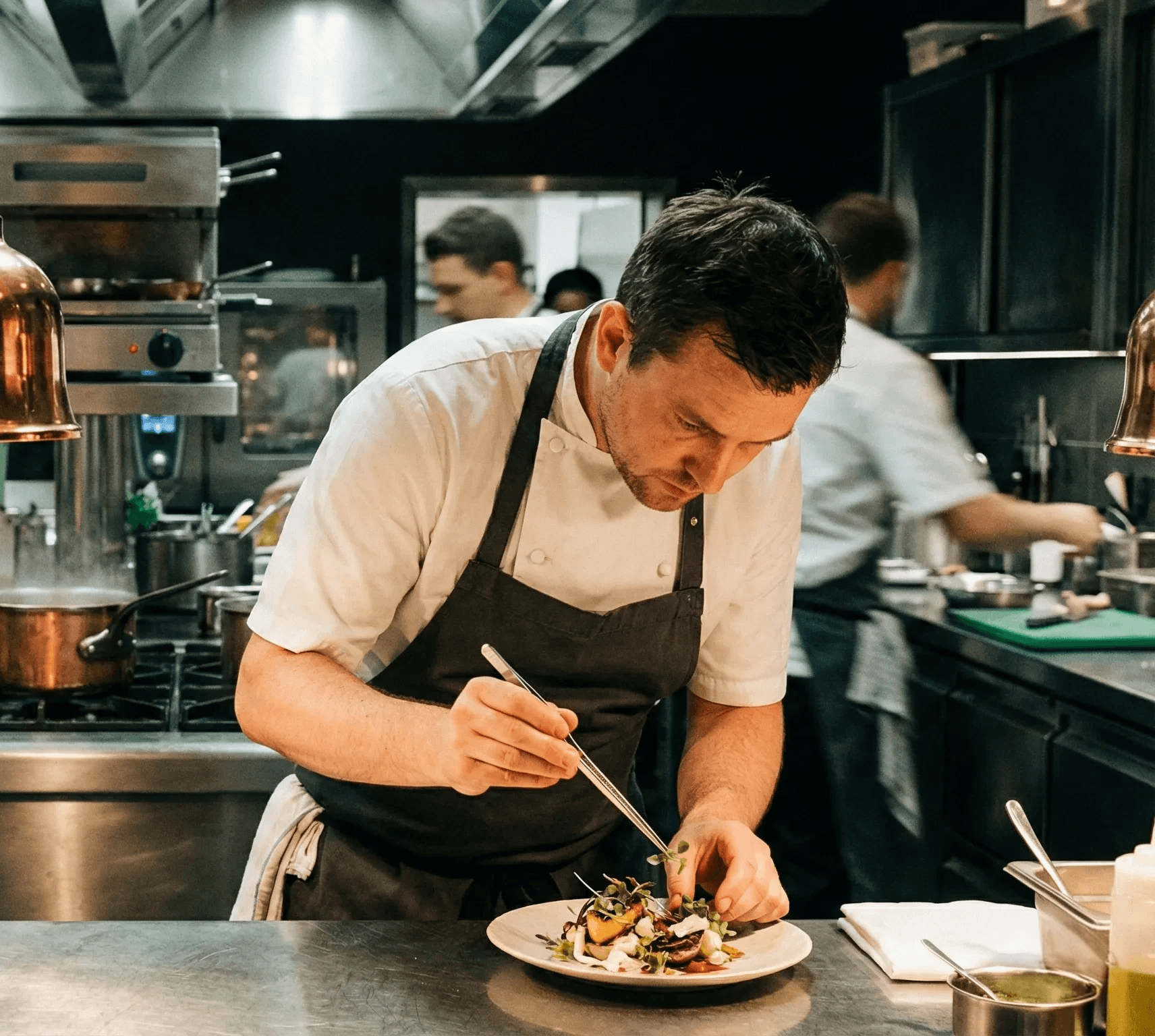 Chef in a bustling kitchen, skillfully plating a dish under warm lighting. Copper pots steam in the background, creating a focused, dynamic atmosphere.
