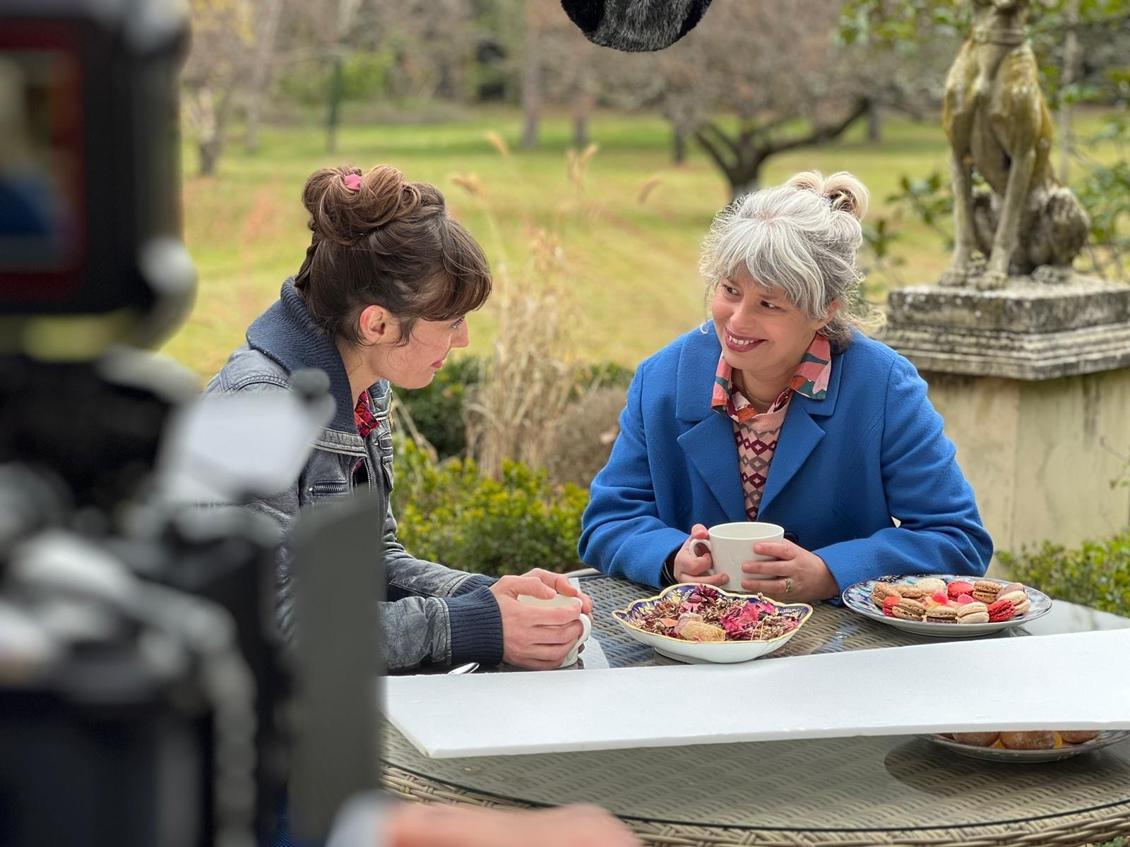 Woman in pink leather jacket crouching outdoors at night