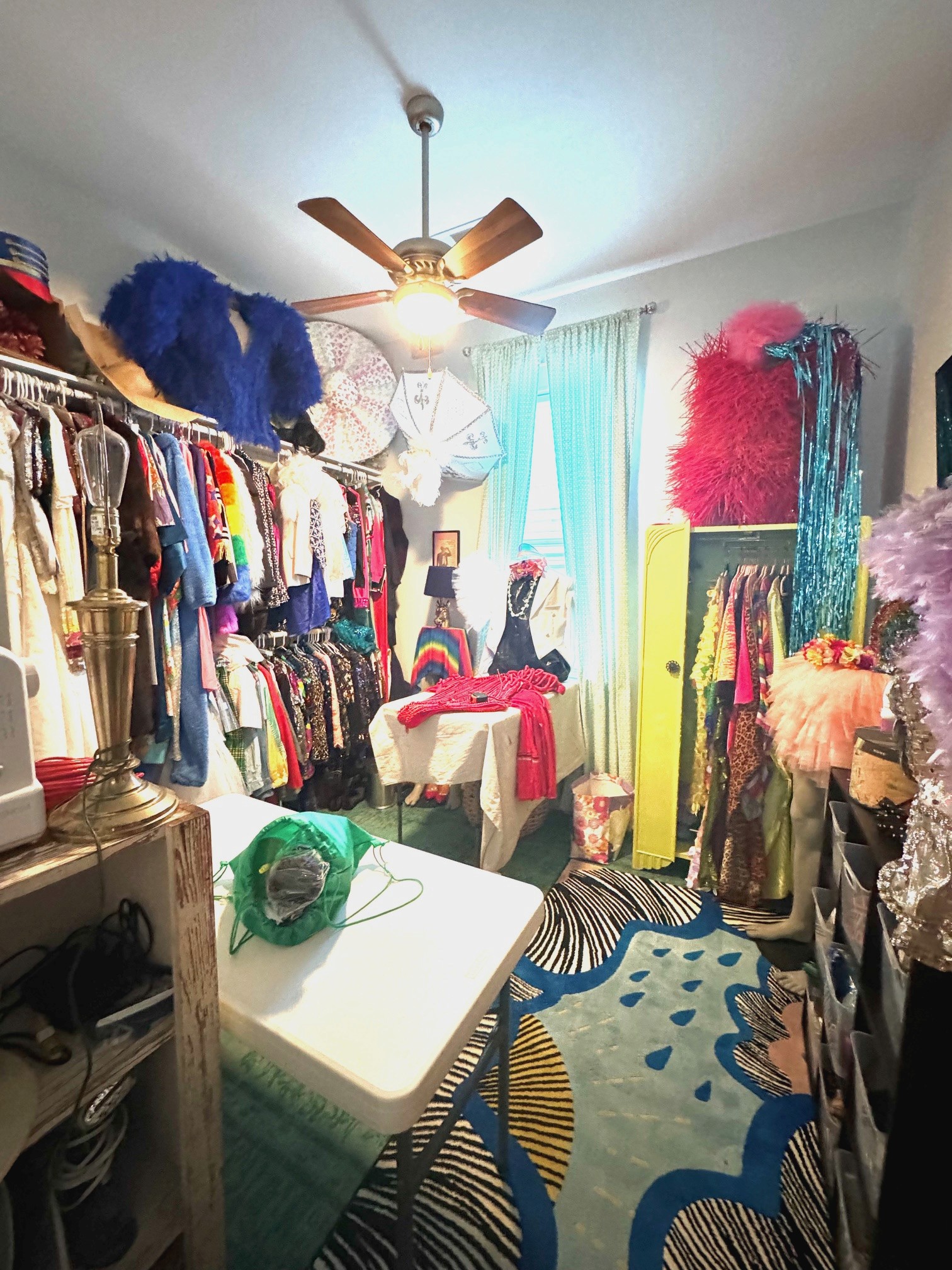 colorful costume room with lots of rugs and costumes and headpieces