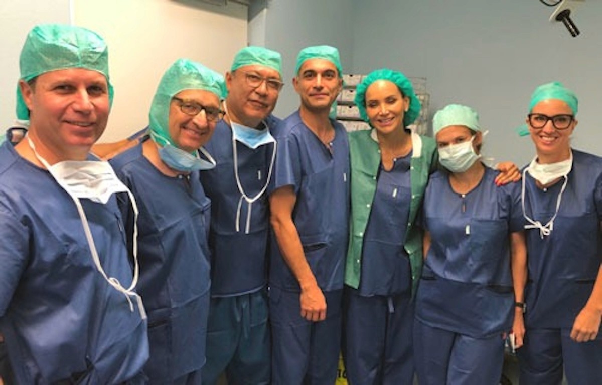 Dr. Mahyar Amjadi with a surgical team in an operating room.