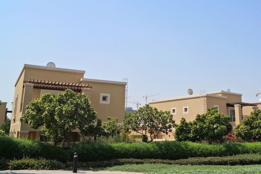 A residential street in Semmer Villas lined with trees and bushes, creating a serene neighborhood atmosphere.