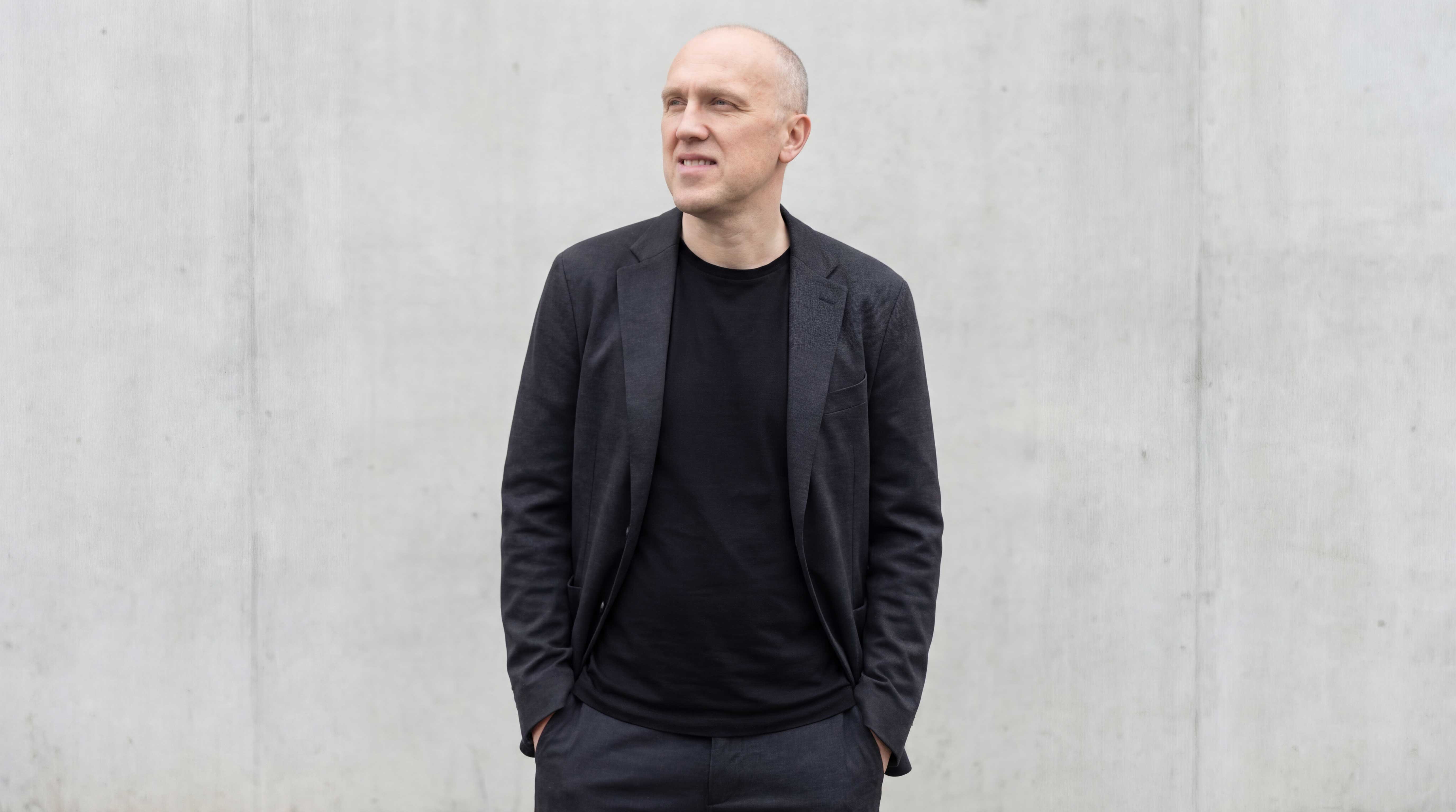 One person stand in front of a brick wall