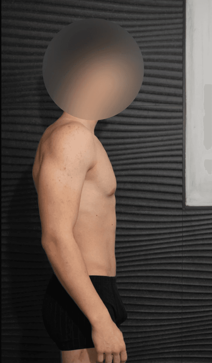 greyscale photo of woman in bralette inside room