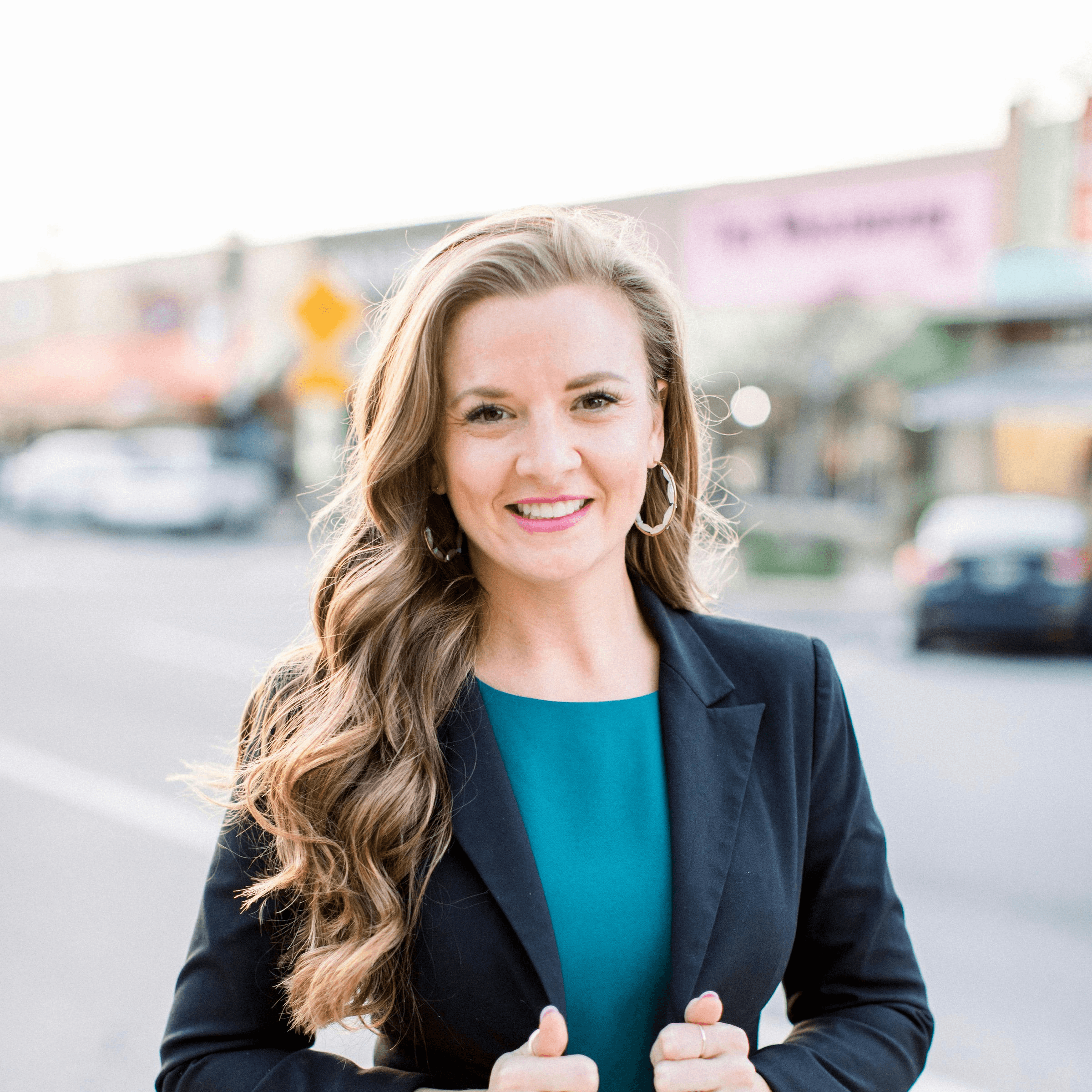 woman in black blazer smiling