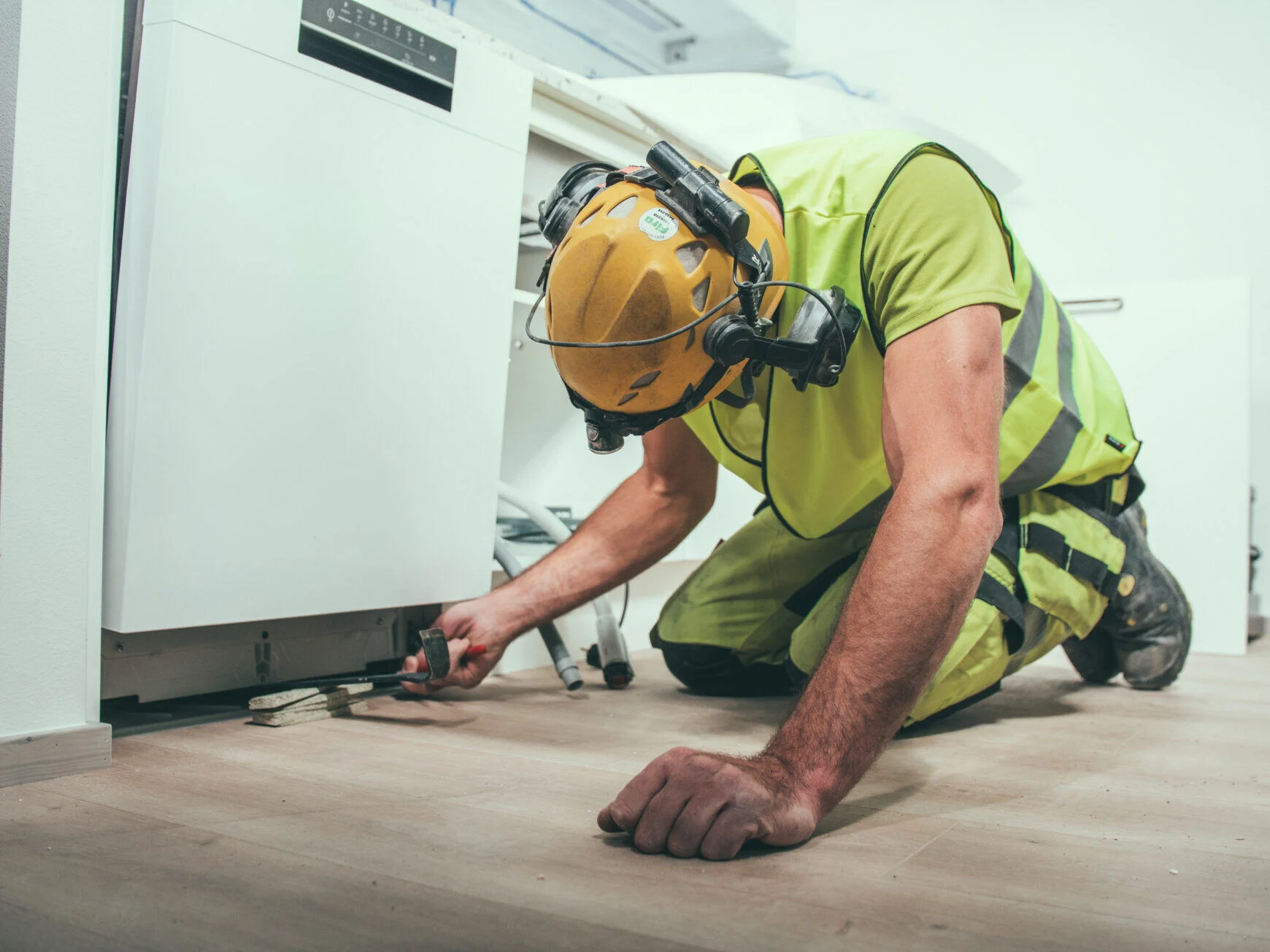 A Finnish construction worker installing a modular kitchen